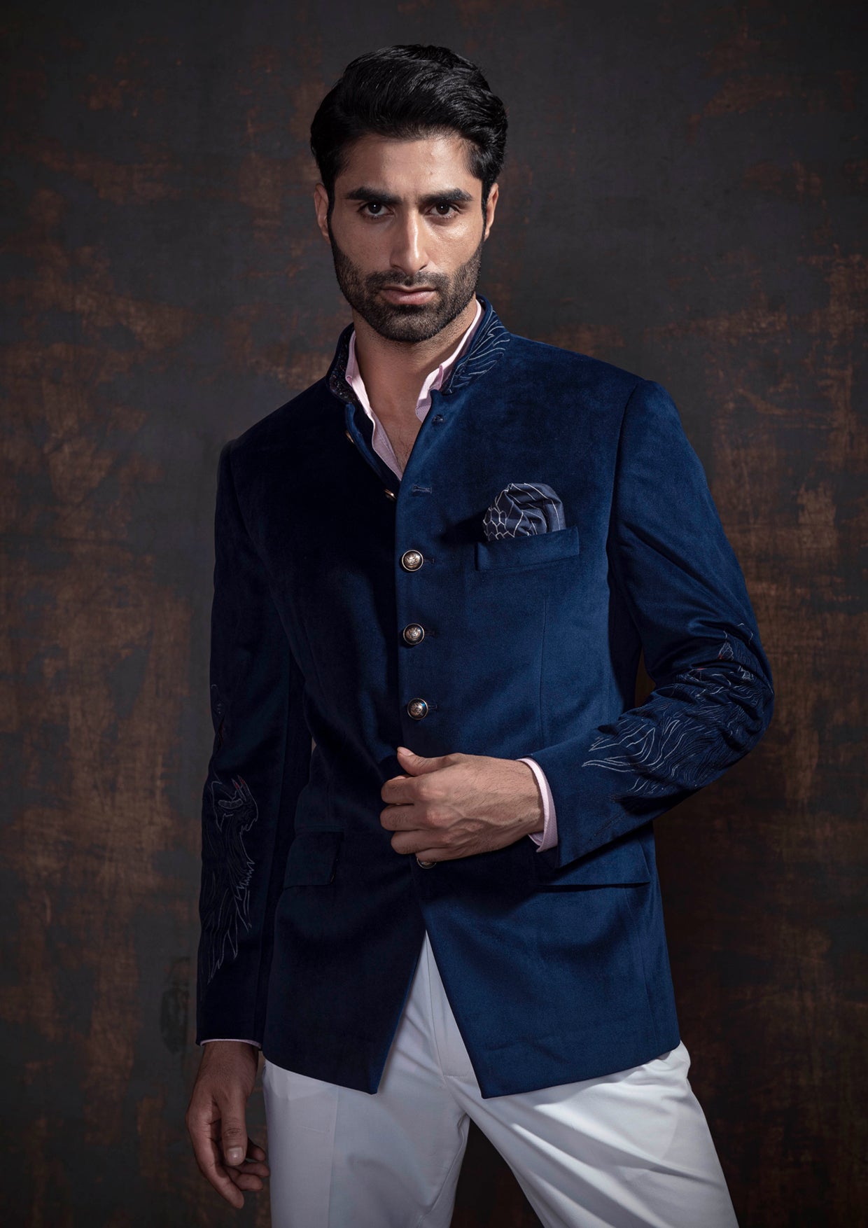 Royal blue velvet bandgala jacket with animal embroidery on the sleeves. Paired up with ivory pants and accessorised with antique gold buttons.