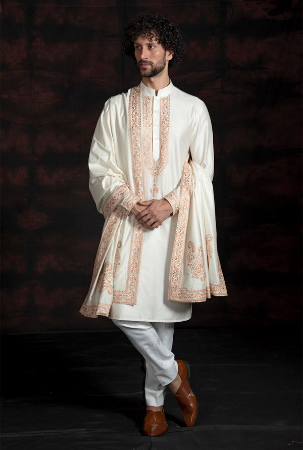Cream coloured kurta with faun coloured embroidery and same coloured stole with the same embroidery.