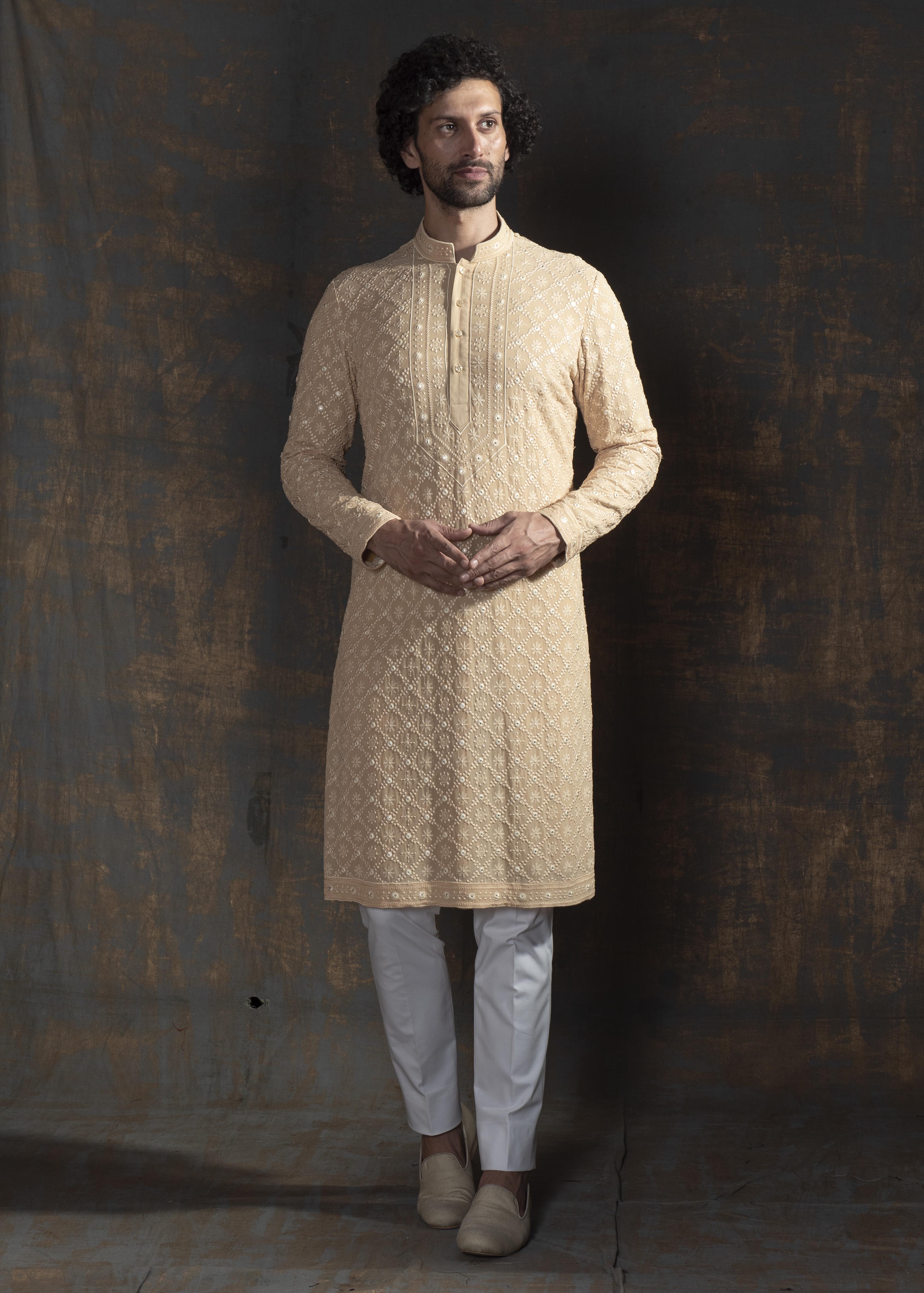 Beige embroidered kurta paired up with ivory pant pajama.