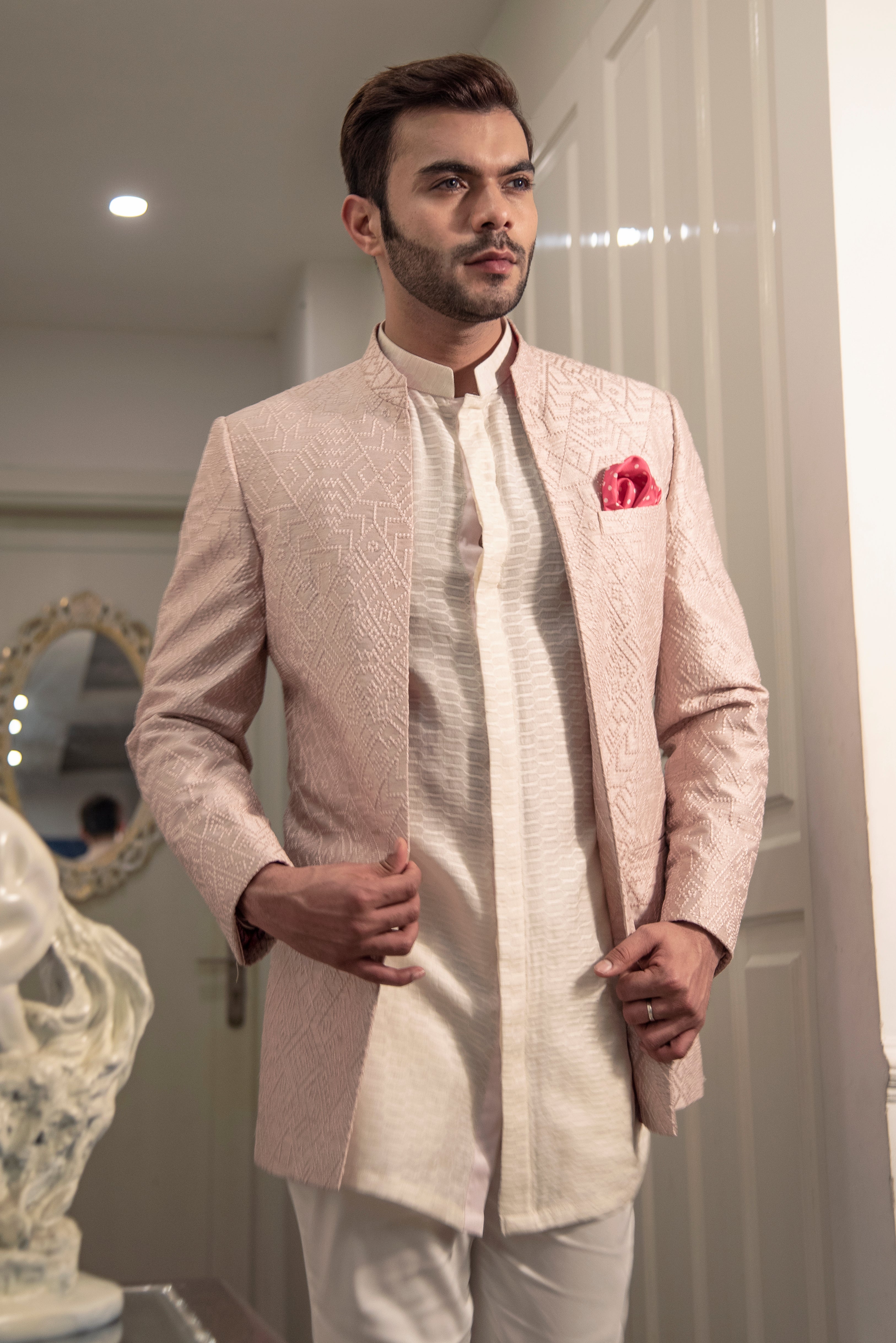 Powder pink embroidered bandgala jacket in open look style. Paired up with embroidered off white long shirt and pant cut pajama.