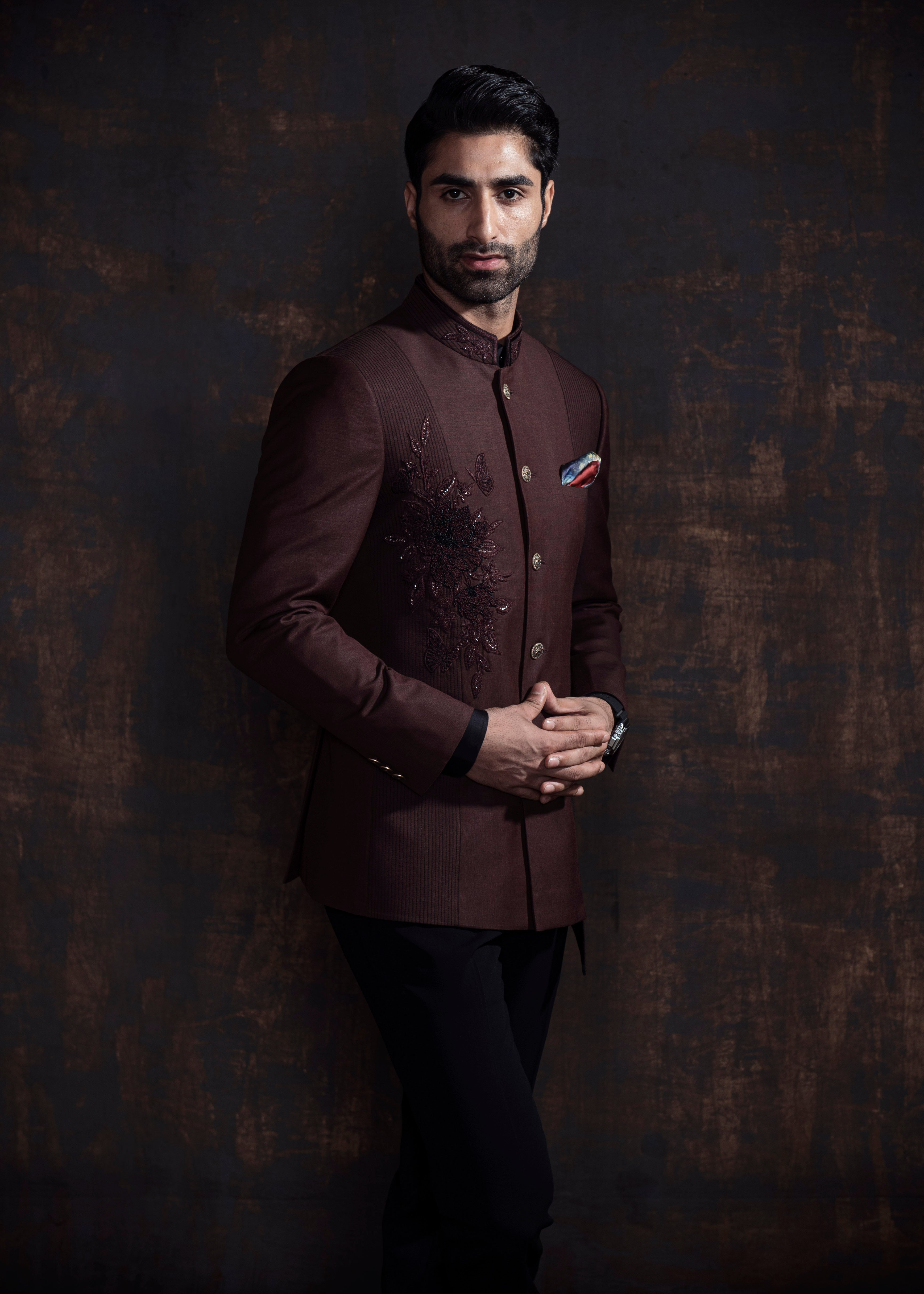 Brown designer, asymmetrical bandgala jacket with black vertical thread work and self on self embroidery. Paired up with jet black pants.