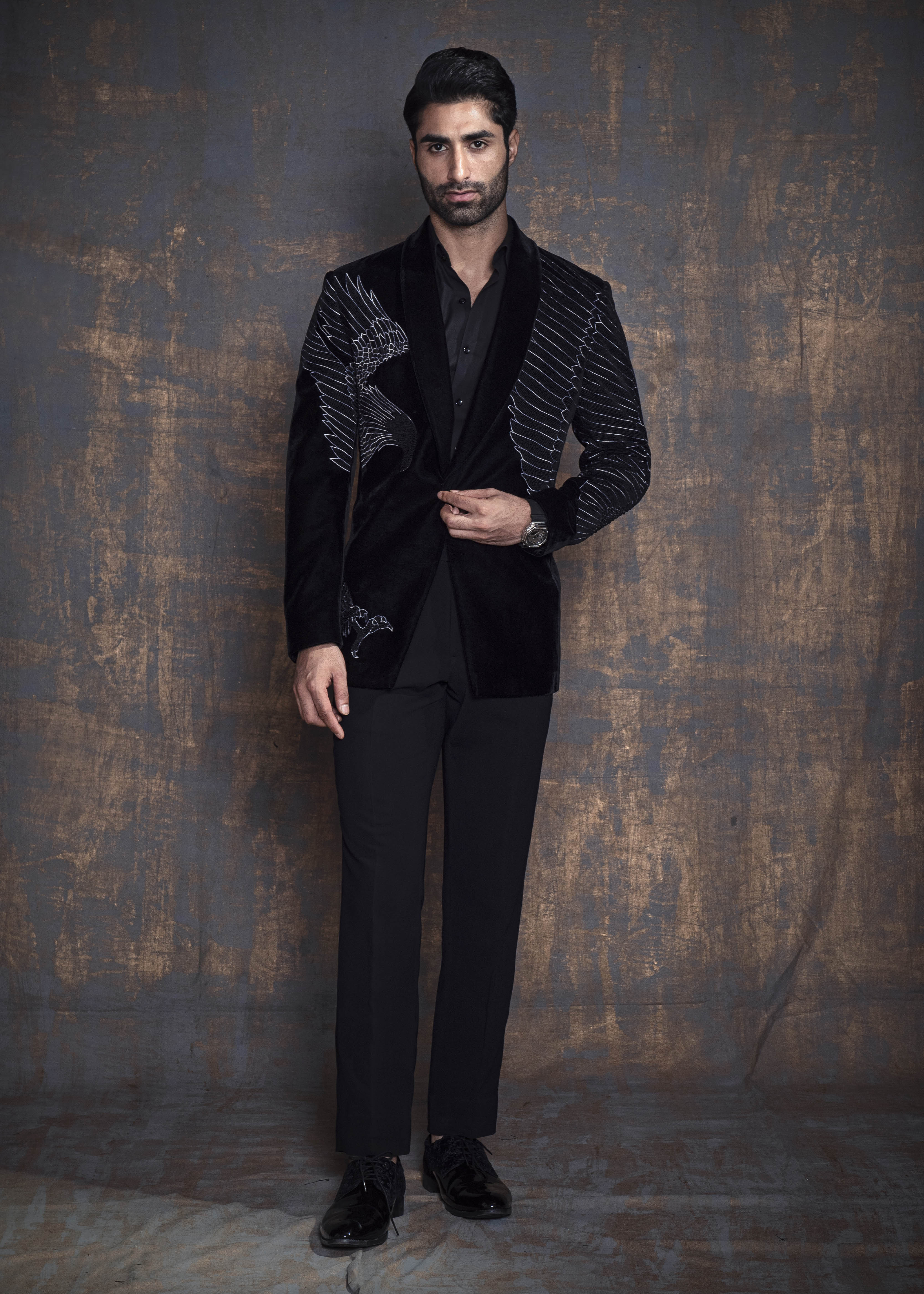 Black cotton velvet tuxedo jacket with animal embroidery. Paired up with jet black pants.