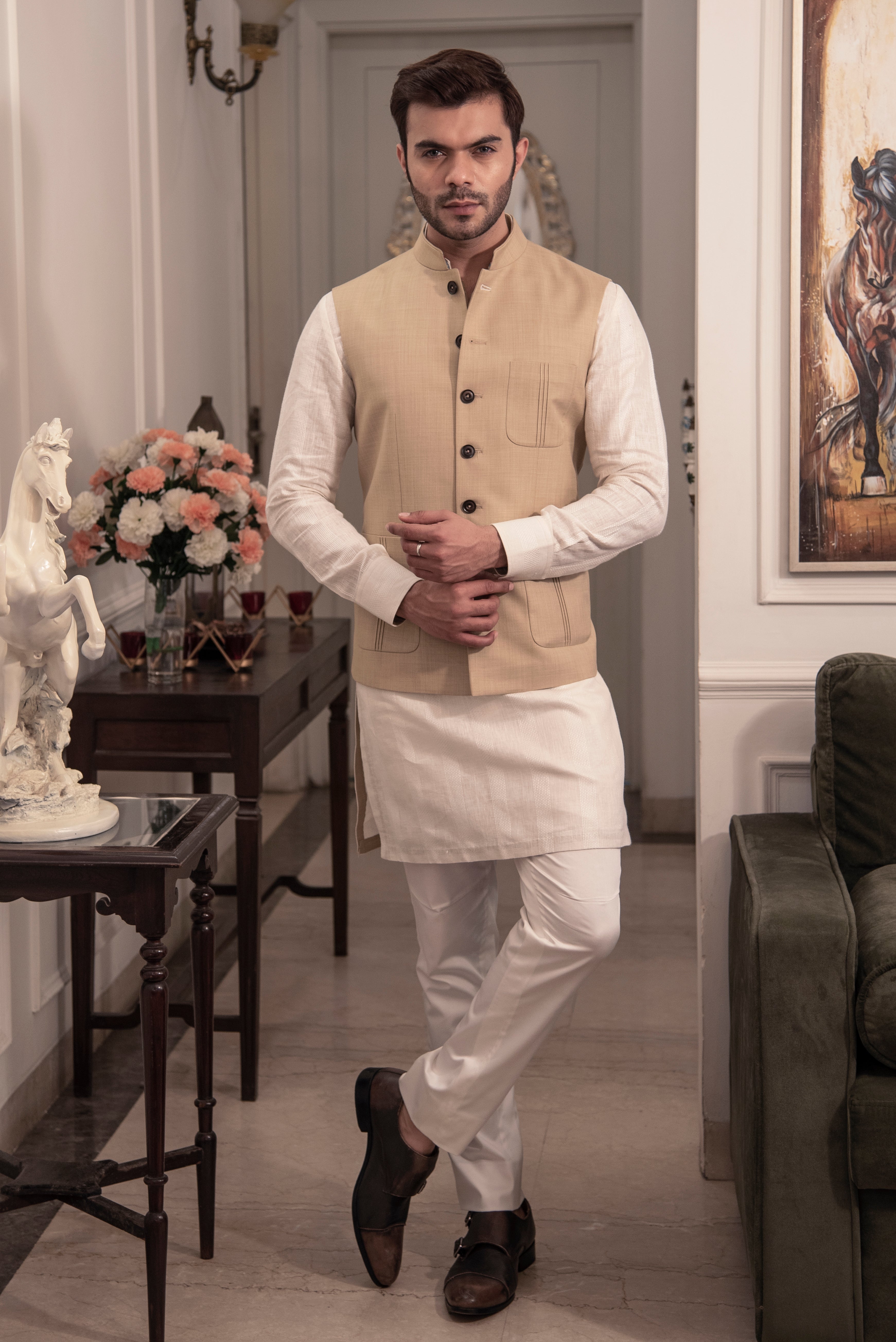 Classic beige nehru jacket. Paired up with off white kurta pajama.