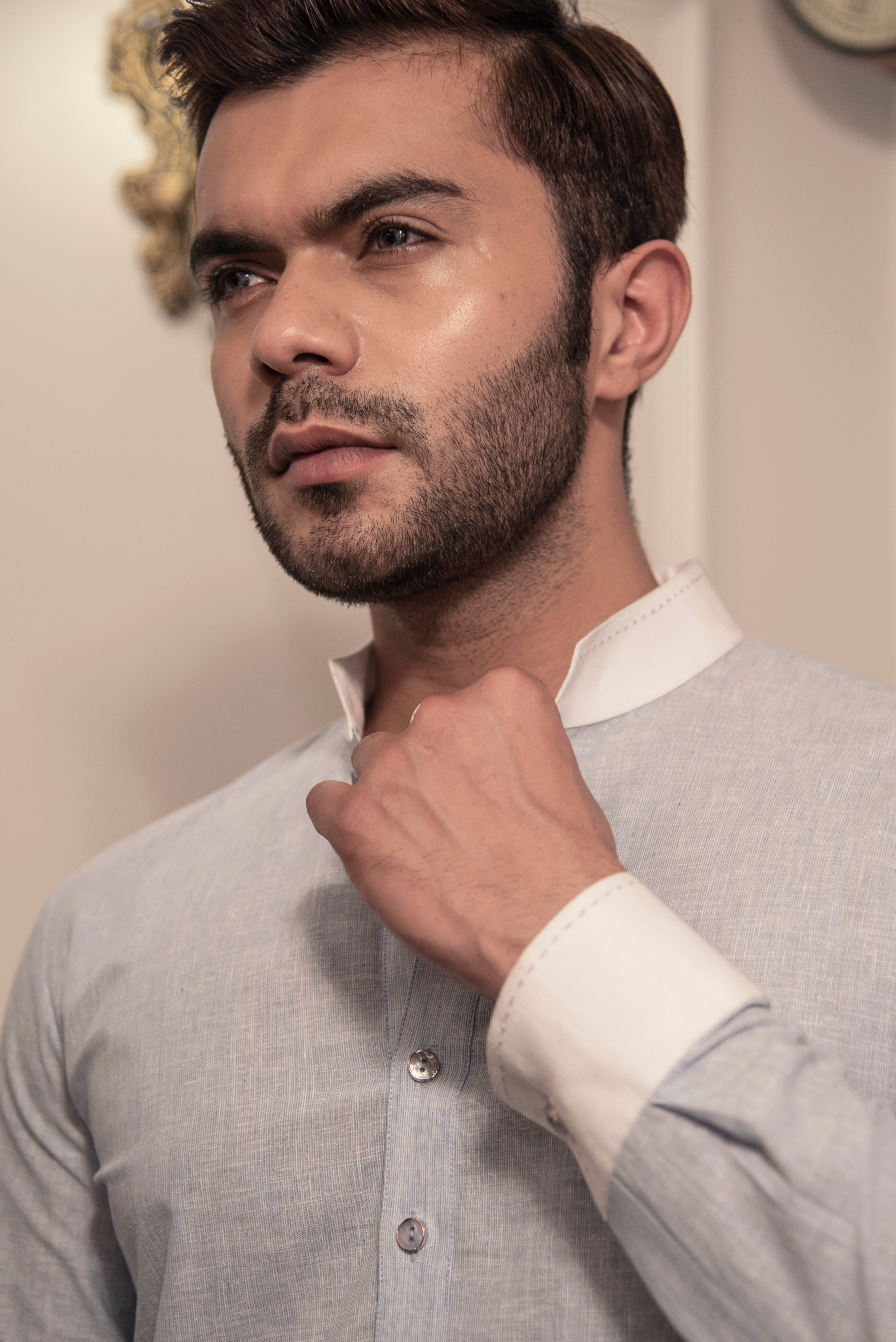 Greyish blue kurta with white collar and cuffs. Paired up with ivory pant cut pajama.