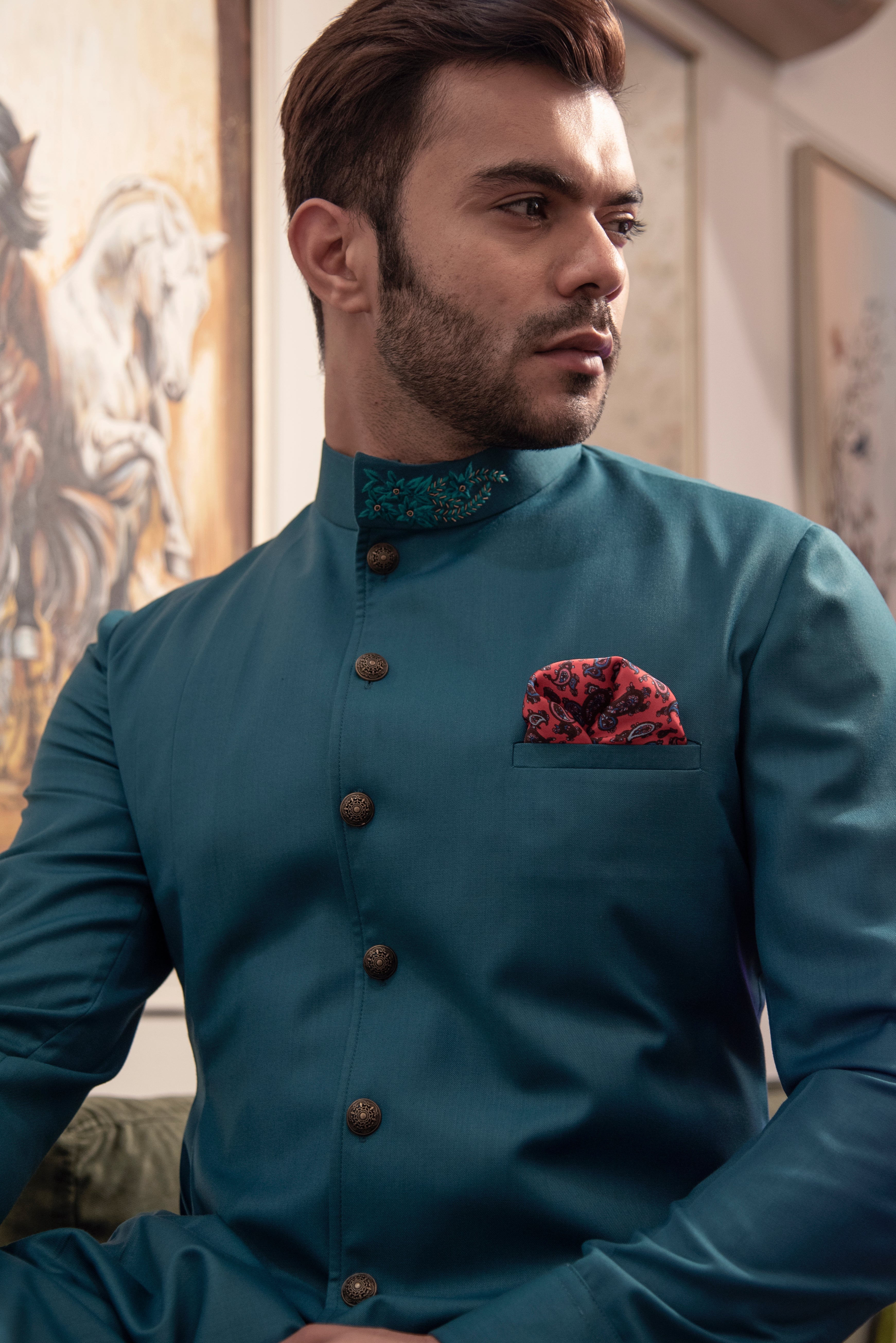 Sea green designer indo cut kurta with self blue coloured embroidery. Paired up with ivory pants.
