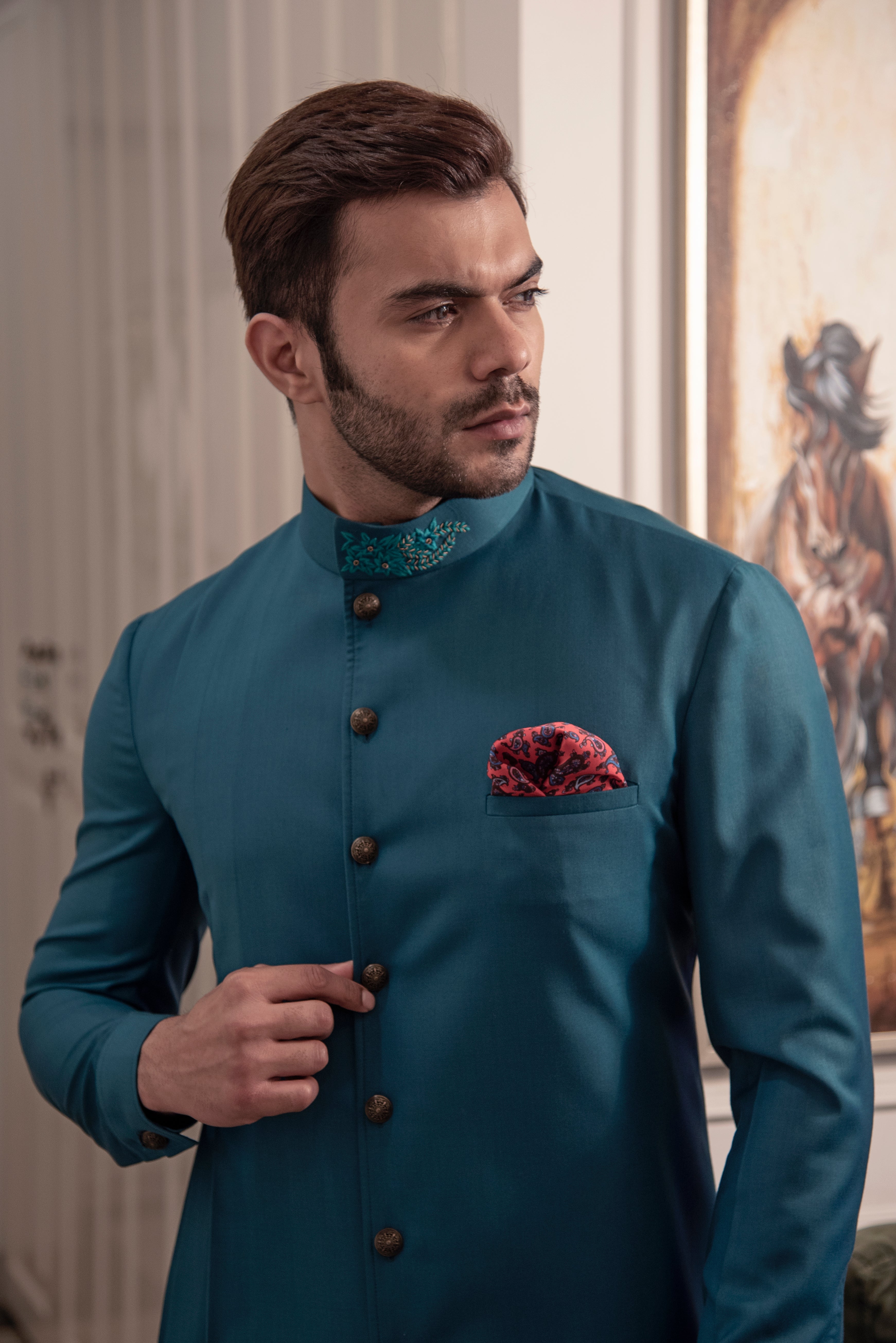 Sea green designer indo cut kurta with self blue coloured embroidery. Paired up with ivory pants.