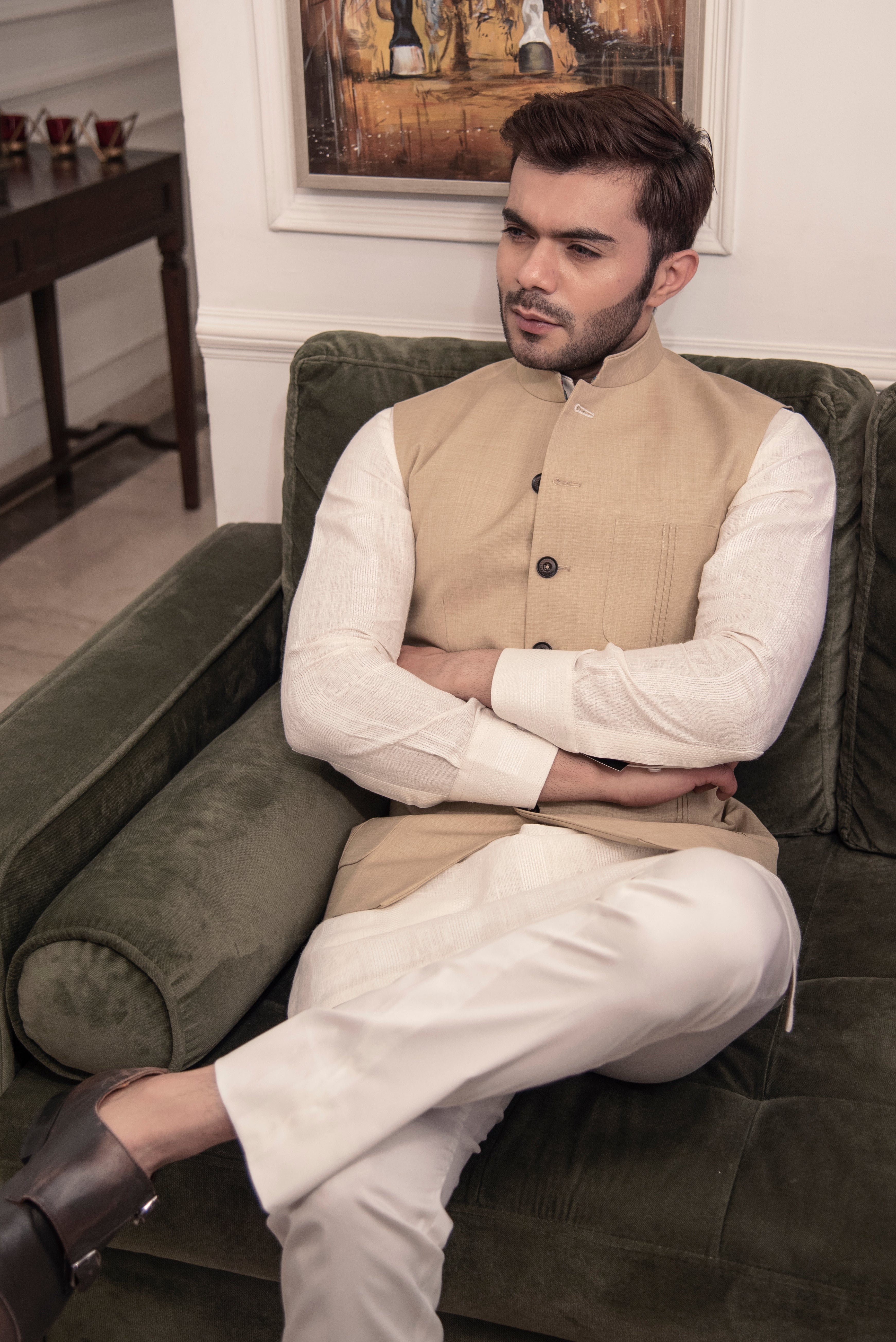 Classic beige nehru jacket. Paired up with off white kurta pajama.