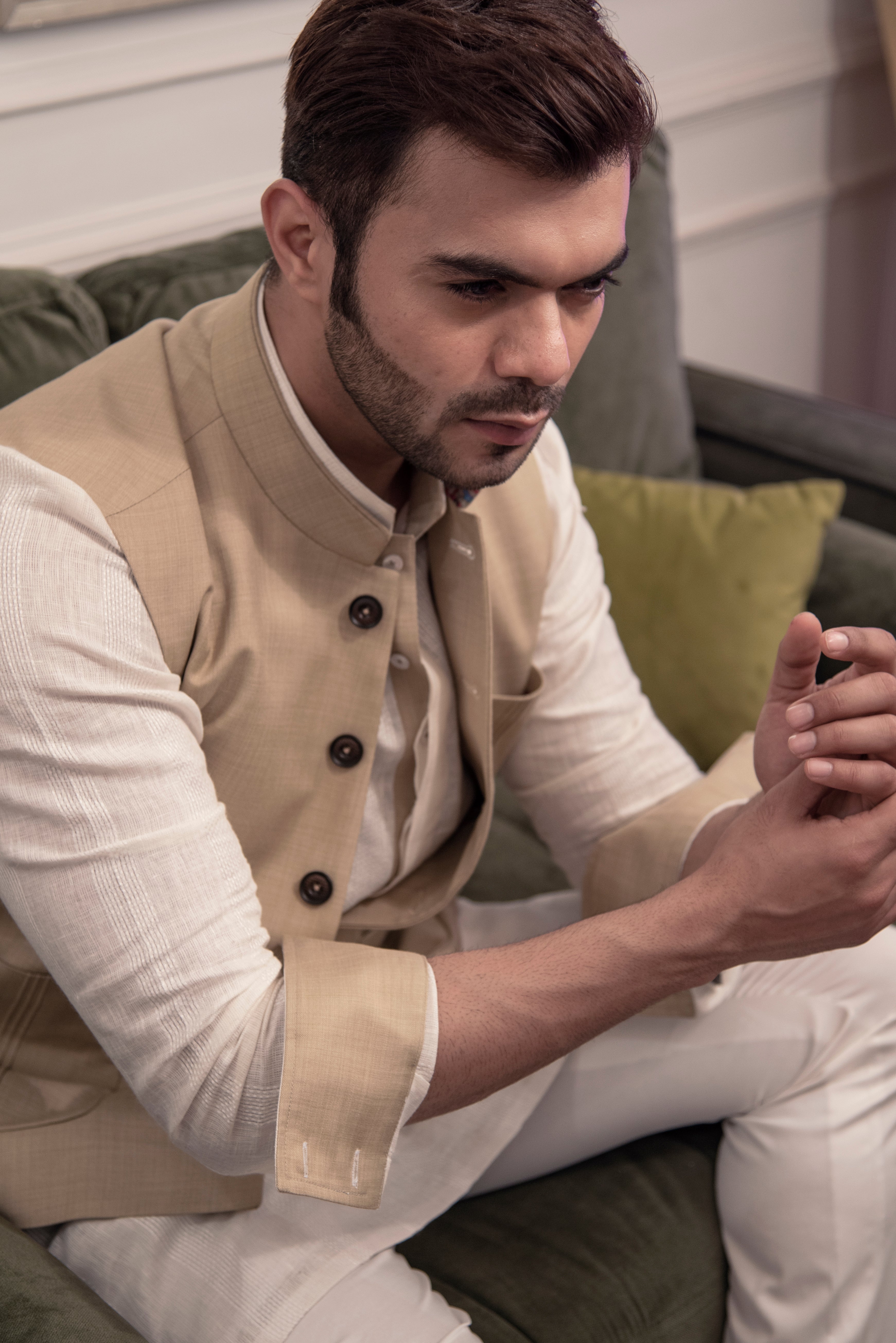Classic beige nehru jacket. Paired up with off white kurta pajama.