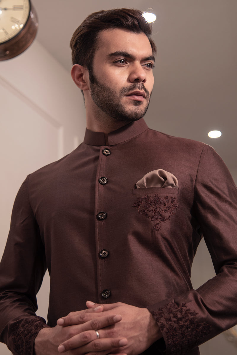 Brown sherwani cut kurta with self coloured embroidery on pocket and cuffs.