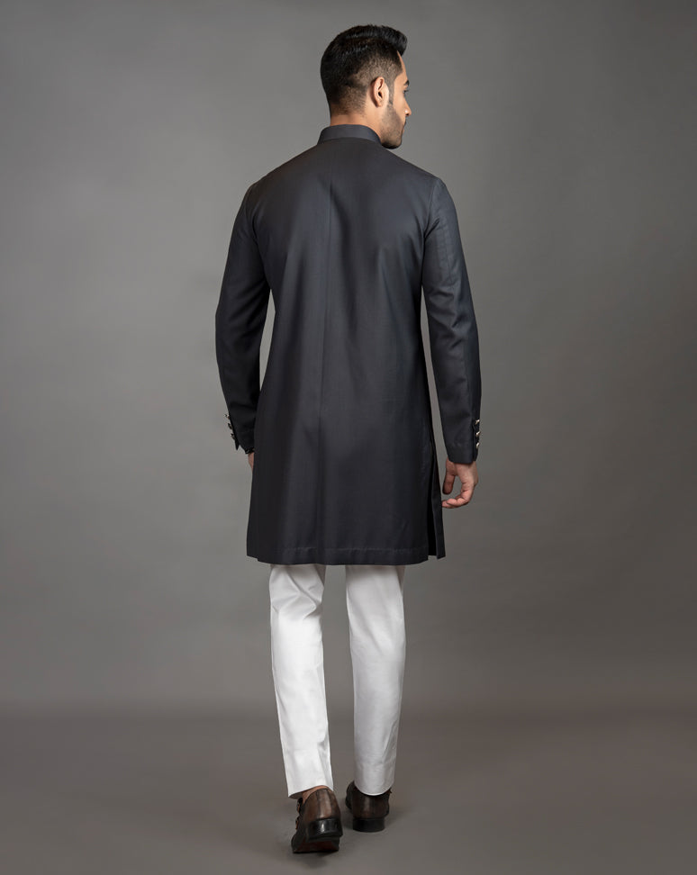 Black asymmetrical sherwani cut kurta with concealed buttons. Paired up with off white pant cut pajama.