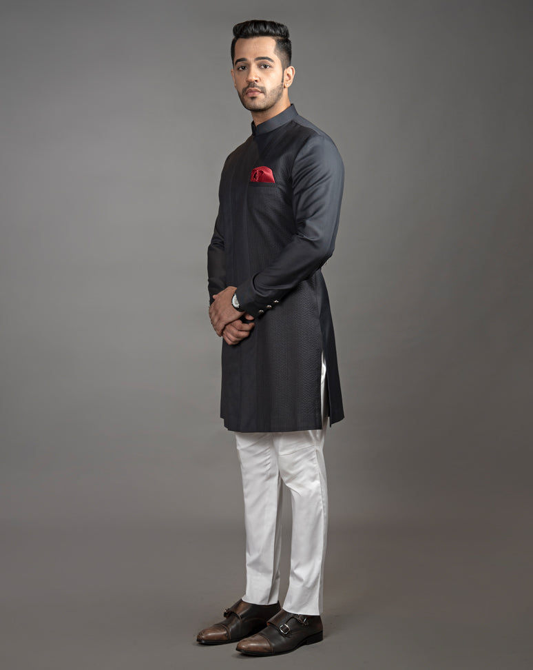 Black asymmetrical sherwani cut kurta with concealed buttons. Paired up with off white pant cut pajama.