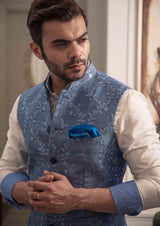 Blue floral embroidered nehru jacket. Paired up with off white kurta and pajama.