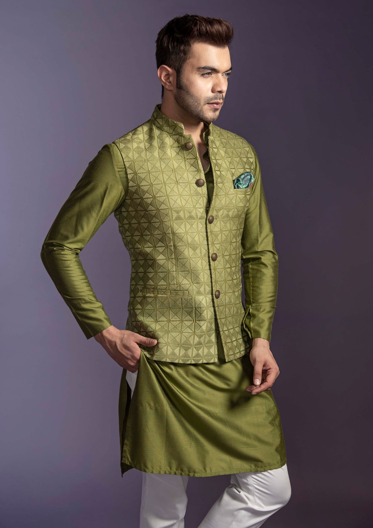 Green embroidered nehru jacket with green silk kurta and off white pant pajama.