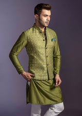 Green embroidered nehru jacket with green silk kurta and off white pant pajama.