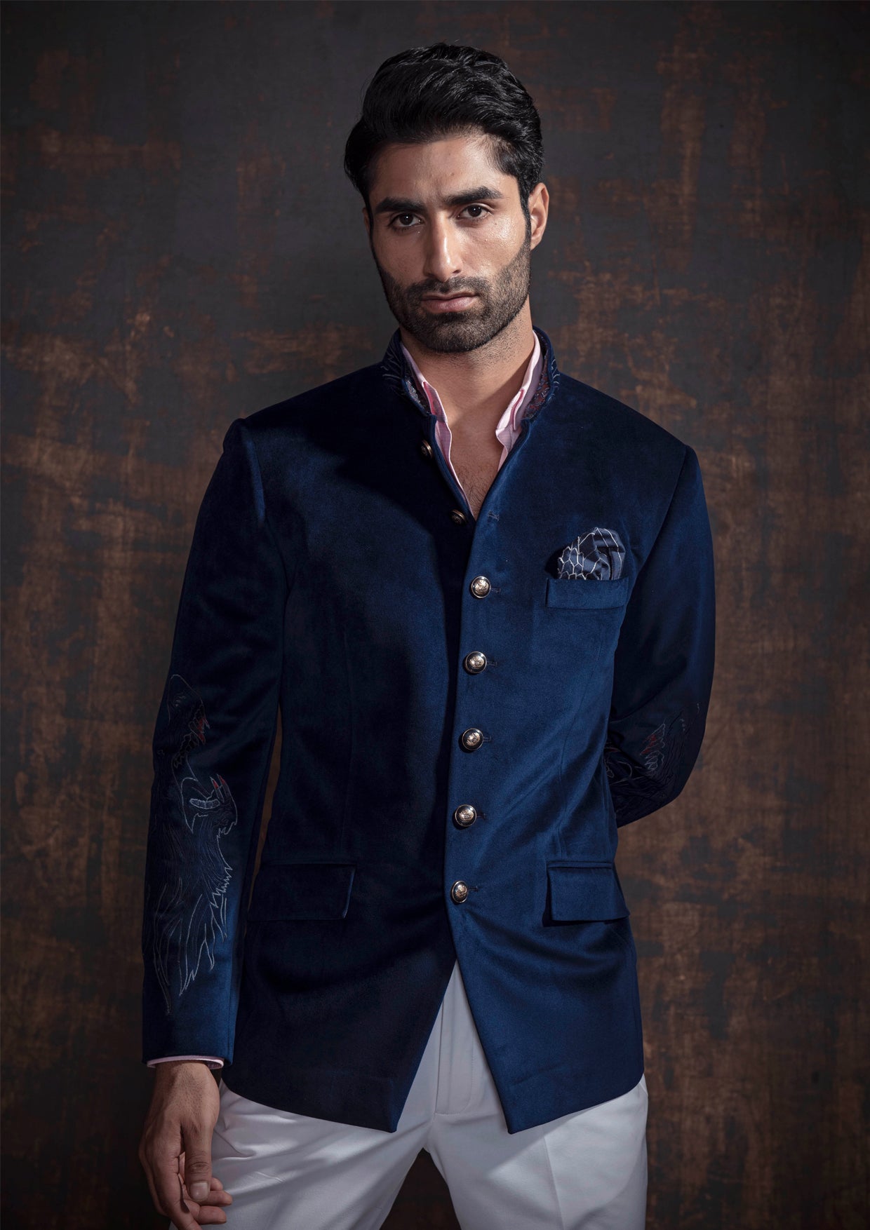 Royal blue velvet bandgala jacket with animal embroidery on the sleeves. Paired up with ivory pants and accessorised with antique gold buttons.