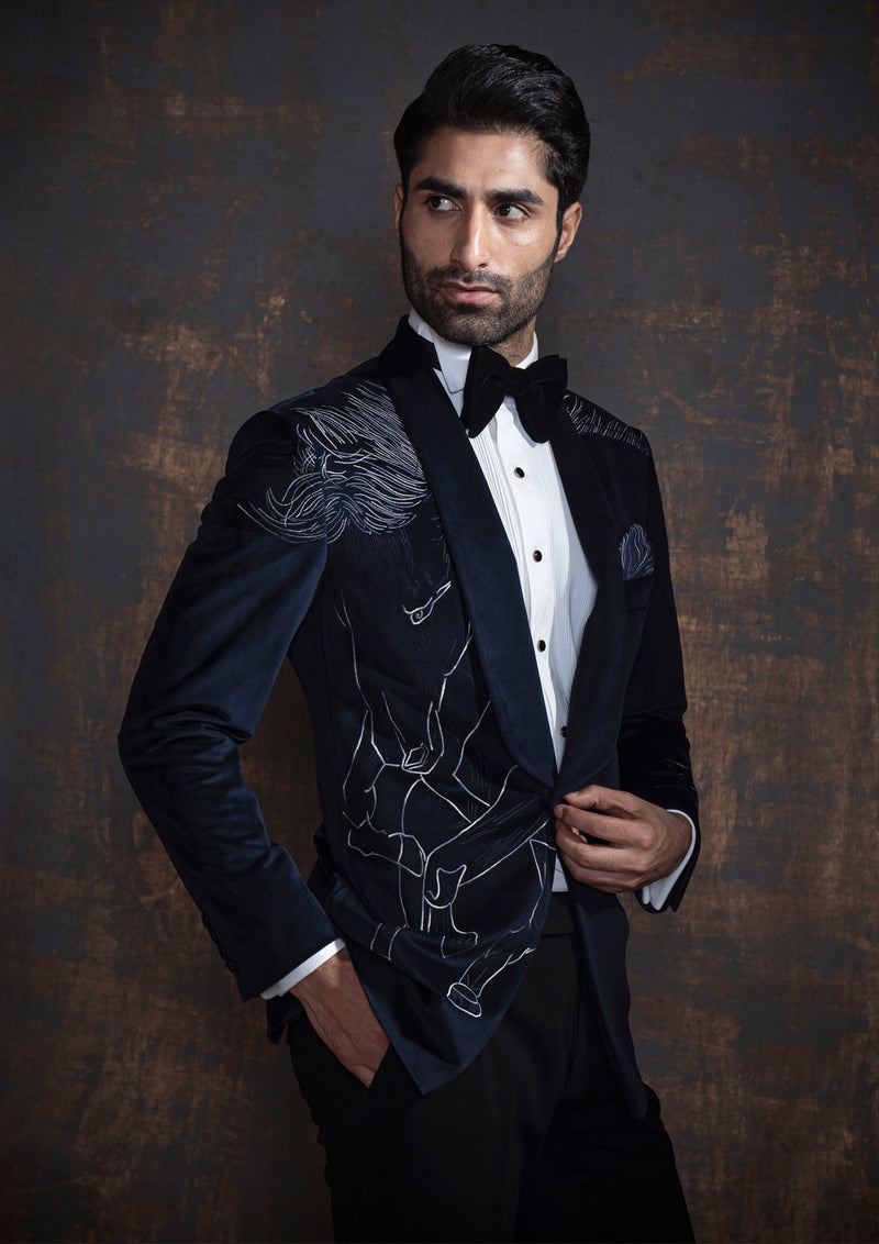 Blue velvet tuxedo with animal embroidery. Paired up with jet black pants.