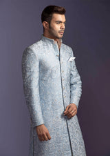 Blue embroidered sherwani with off white pajama.