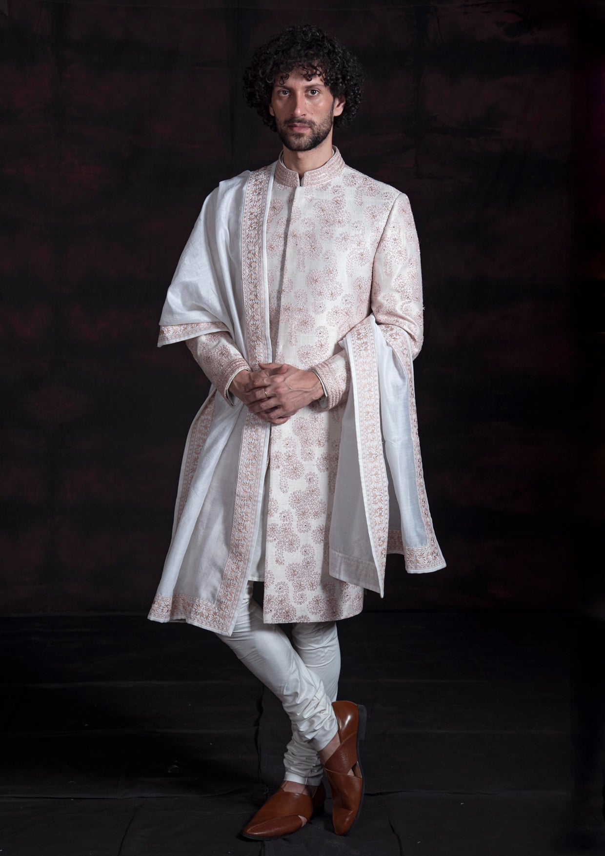 Ivory sherwani with pink thread work.