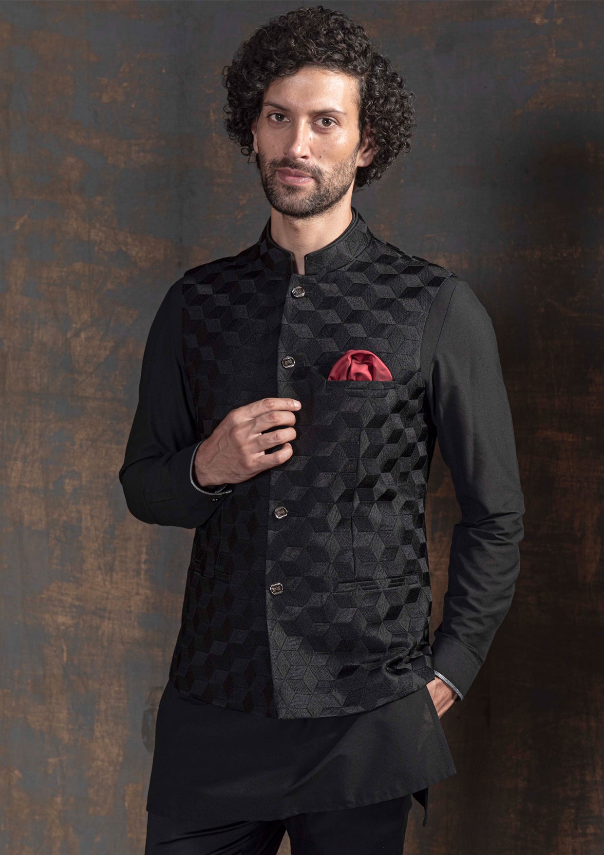 Black self embroidered nehru jacket. Paired up with black kurta pajama.