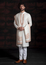 Cream coloured kurta with faun coloured embroidery and same coloured stole with the same embroidery.