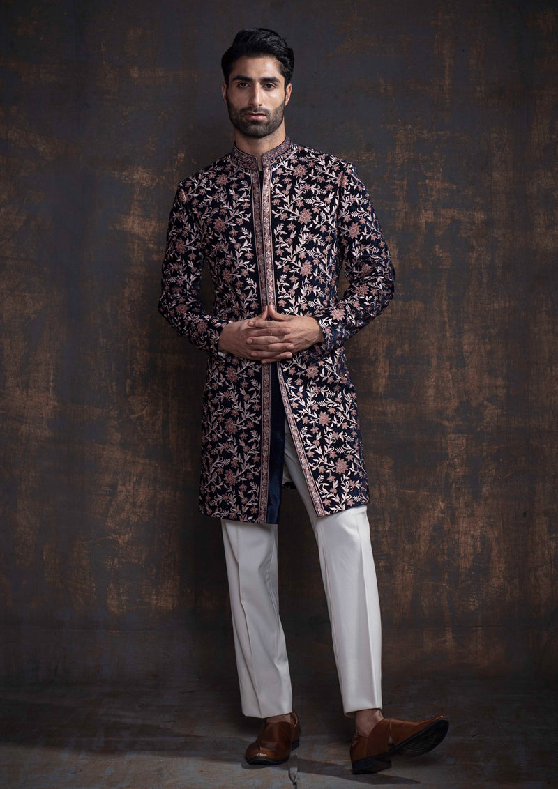 Blue velvet indo western with all over beige and brown embroidery. Paired up with ivory pants.
