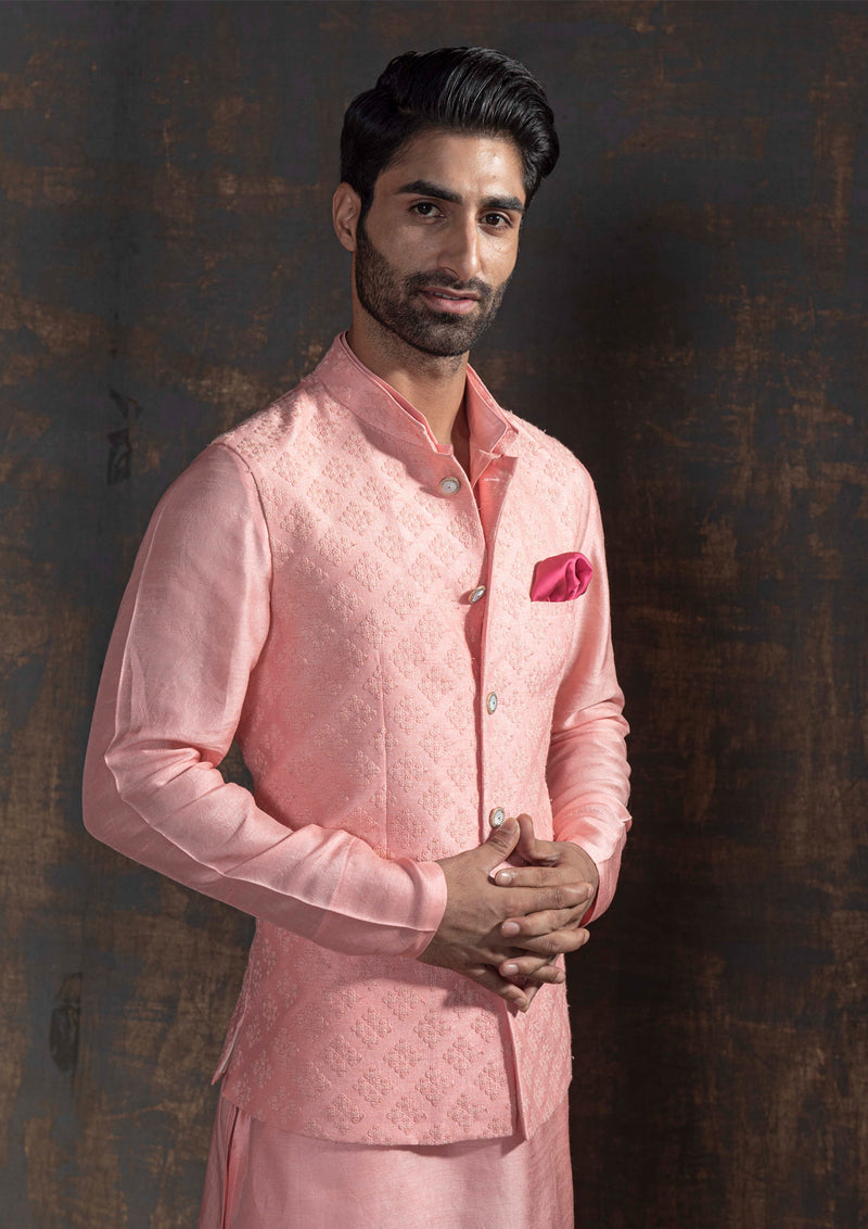 Pink self embroidered nehru jacket.  Paired up with pink kurta and ivory pajama.