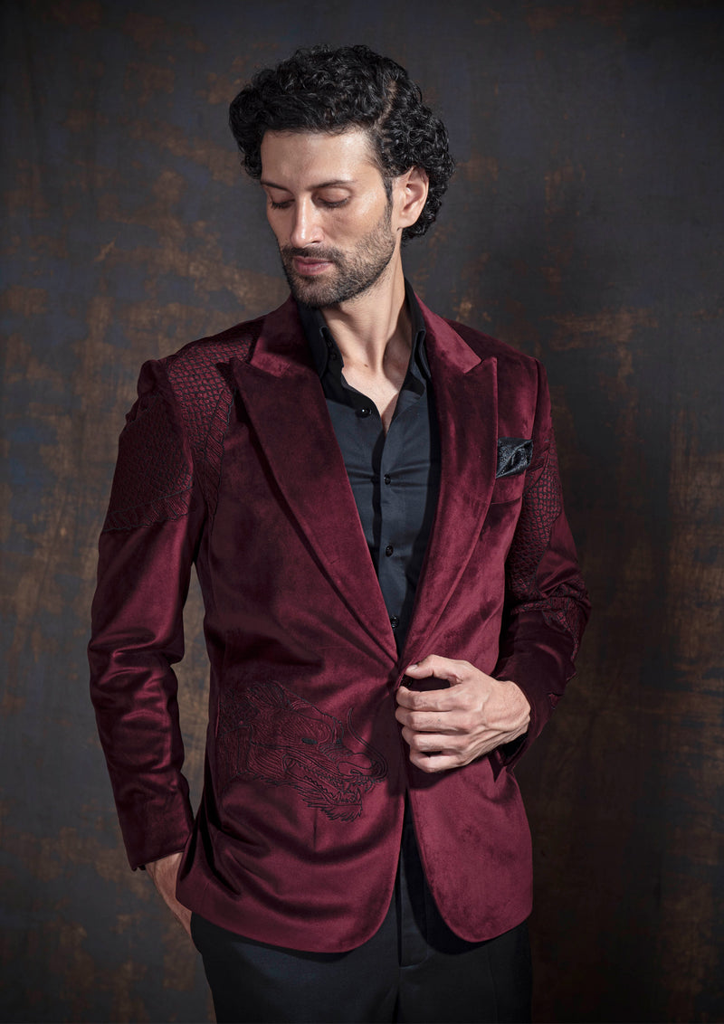 Deep red velvet tuxedo with animal embroidery.  Paired up with jet black pants.
