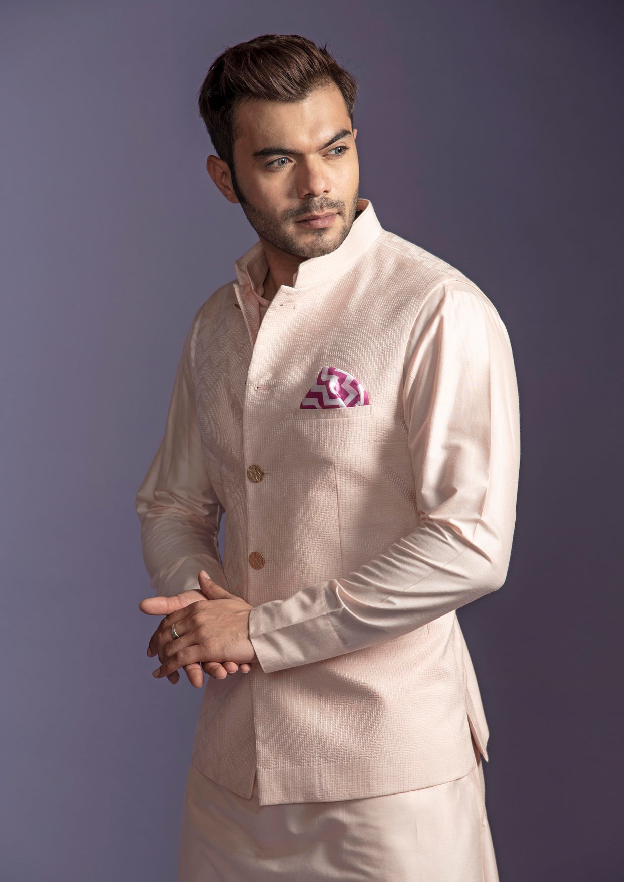 Peach nehru jacket with peach kurta and off white pant pajama.