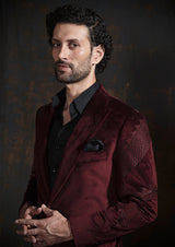 Deep red velvet tuxedo with animal embroidery.  Paired up with jet black pants.