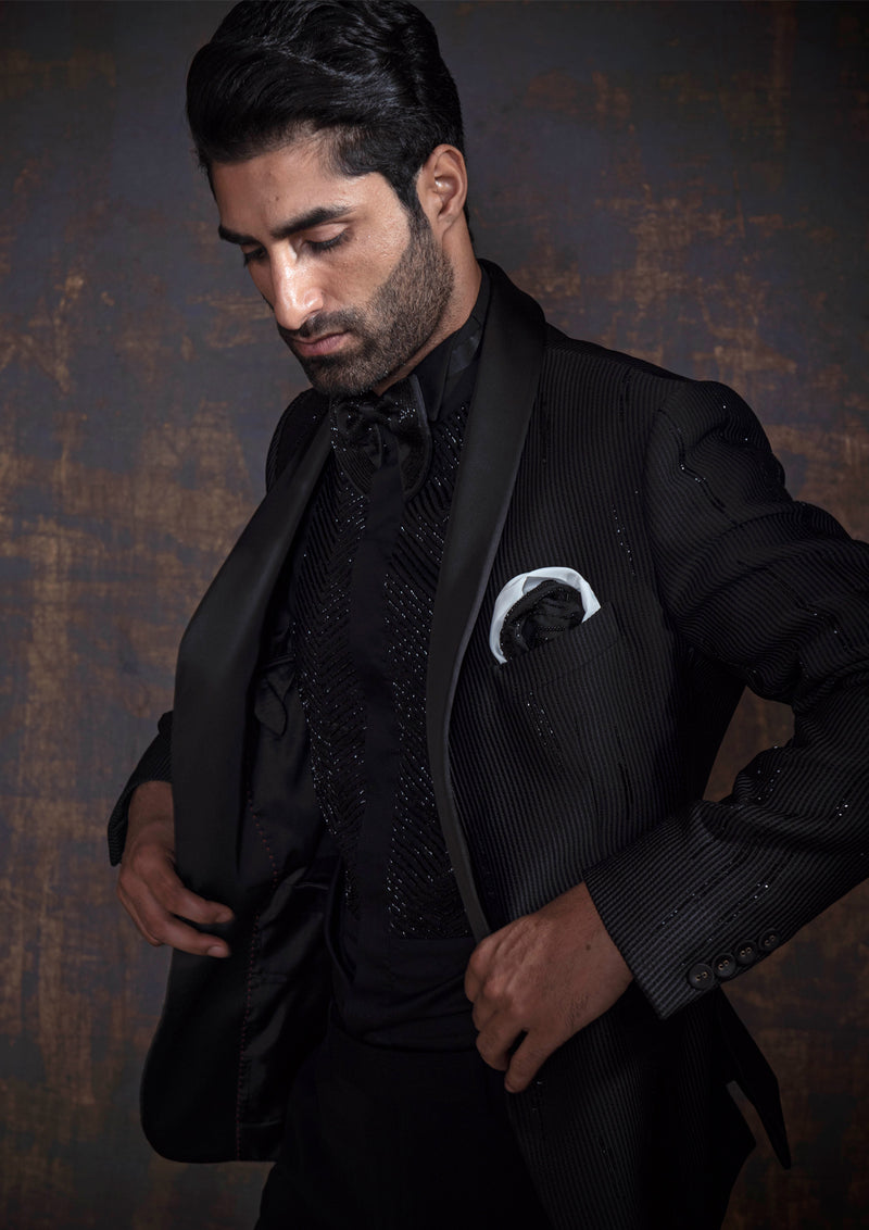 Black self tuxedo with hand embroidery.