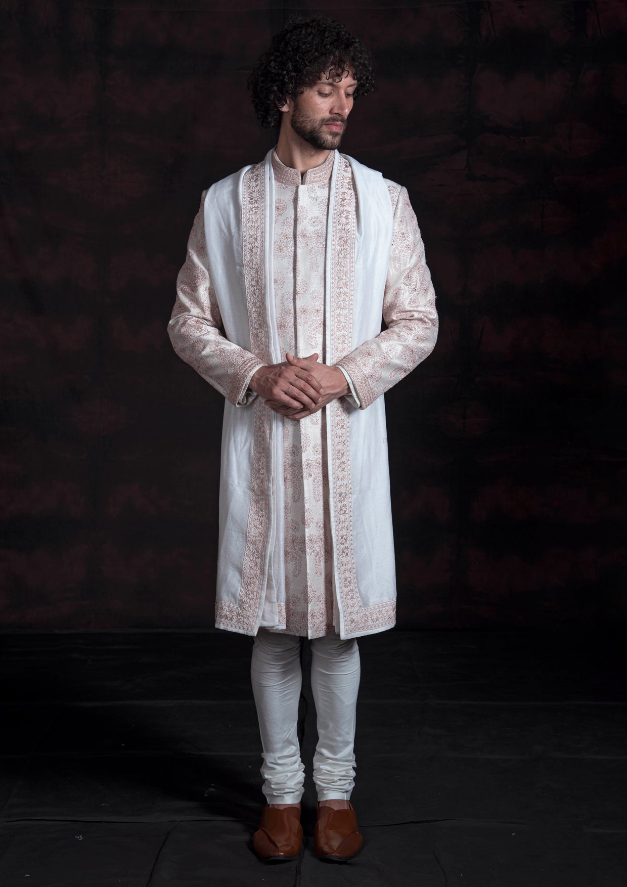 Ivory sherwani with pink thread work.