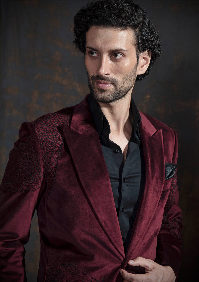 Deep red velvet tuxedo with animal embroidery.  Paired up with jet black pants.