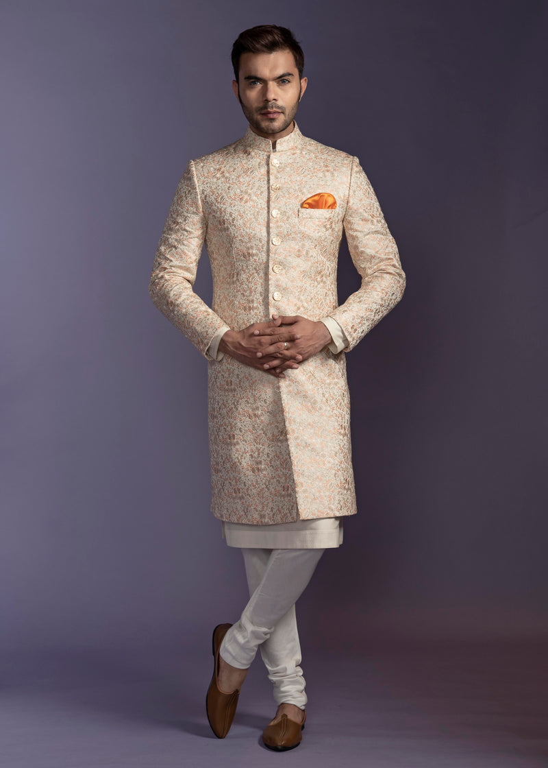 Off white sherwani with multi coloured embroidery all over and paired up with off white kurta pajama.