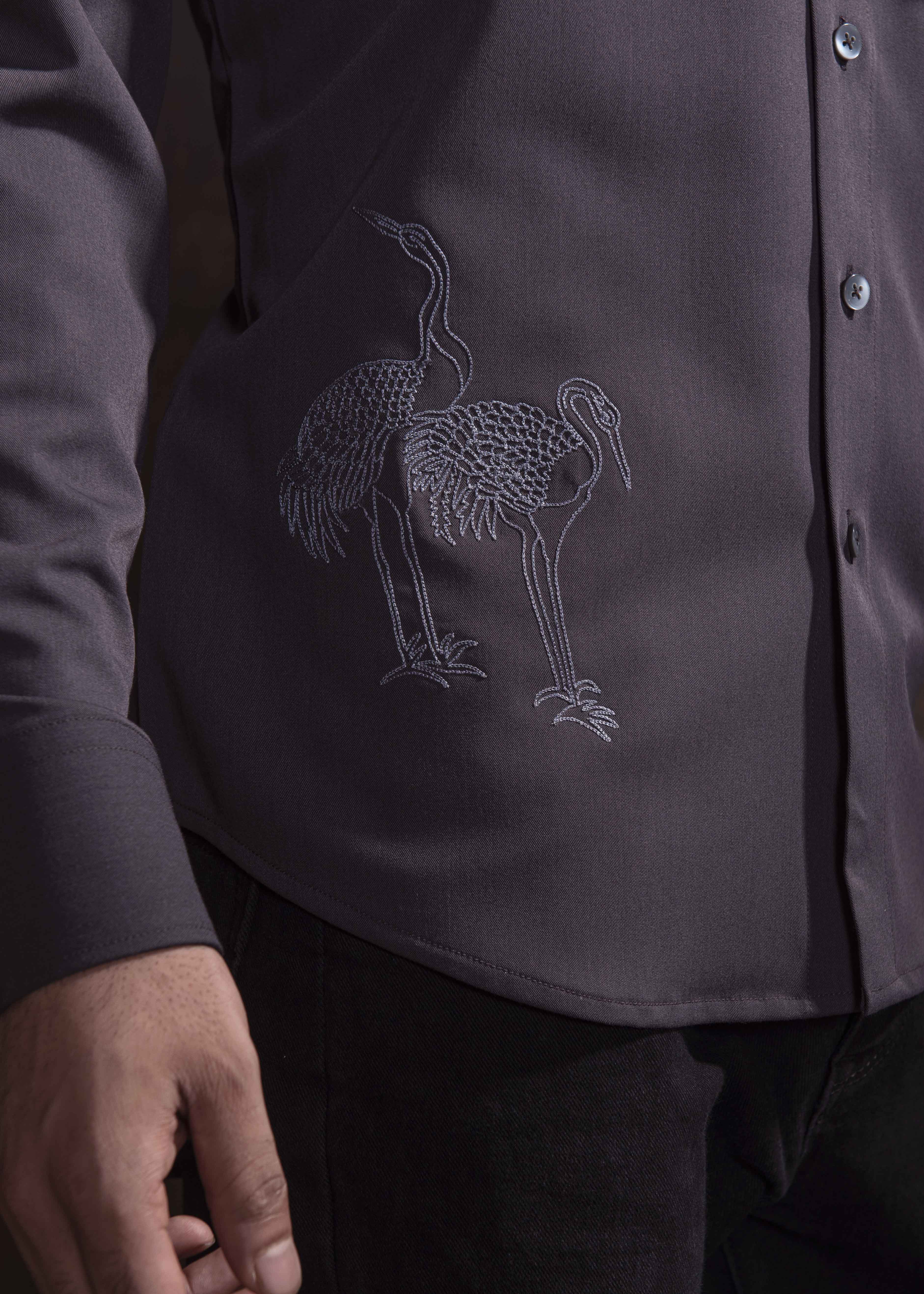 Grey shirt with grey embroidery.