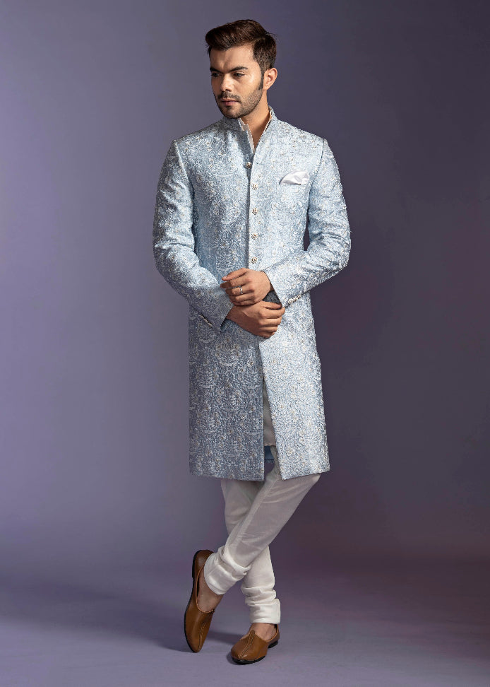 Blue embroidered sherwani with off white pajama.
