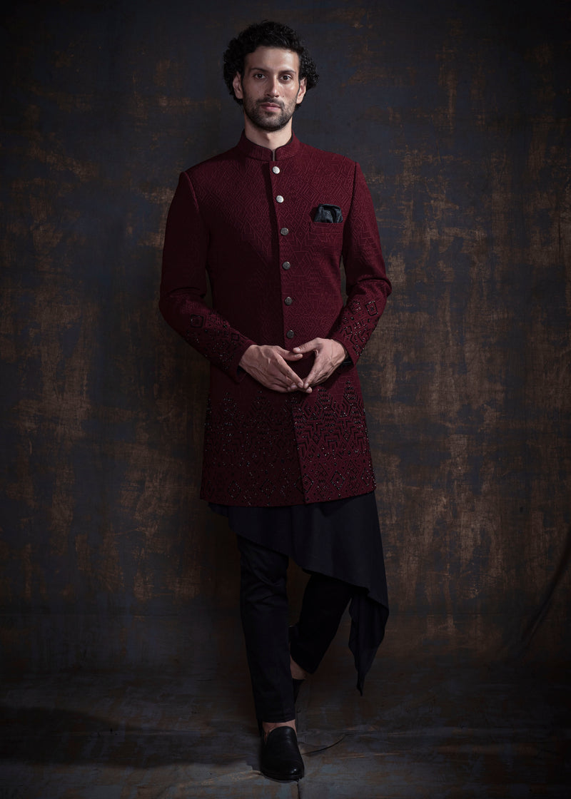 Red embroidered indo western with black hand embroidery. Paired up with black kurta and pajama.
