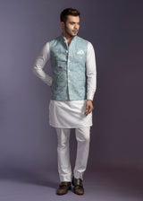 Turquoise blue nehru jackey with off white embroidery paired up with off white kurta pajama.
