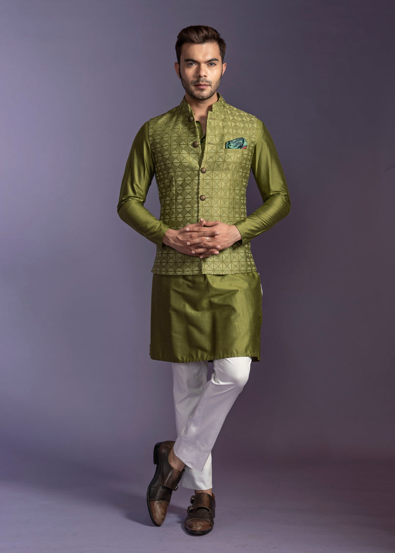 Green embroidered nehru jacket with green silk kurta and off white pant pajama.