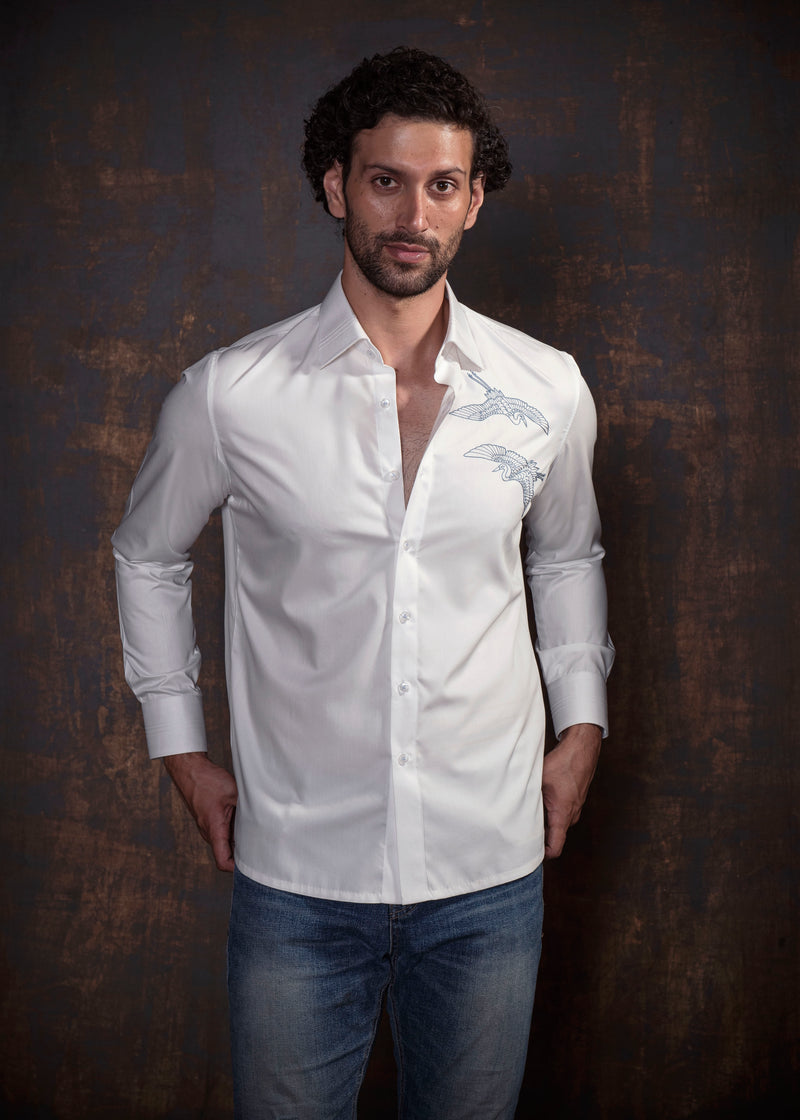 White shirt with blue embroidery.