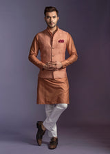Rust shade nehru jacket and kurta with off white pant pajama.