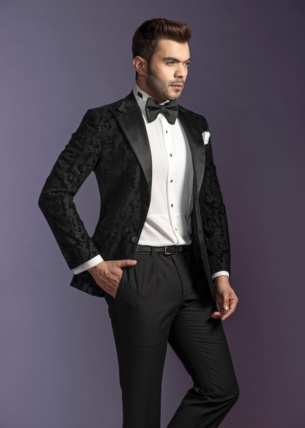 Black self tuxedo with peak lapel. Paired up with jet black pants.