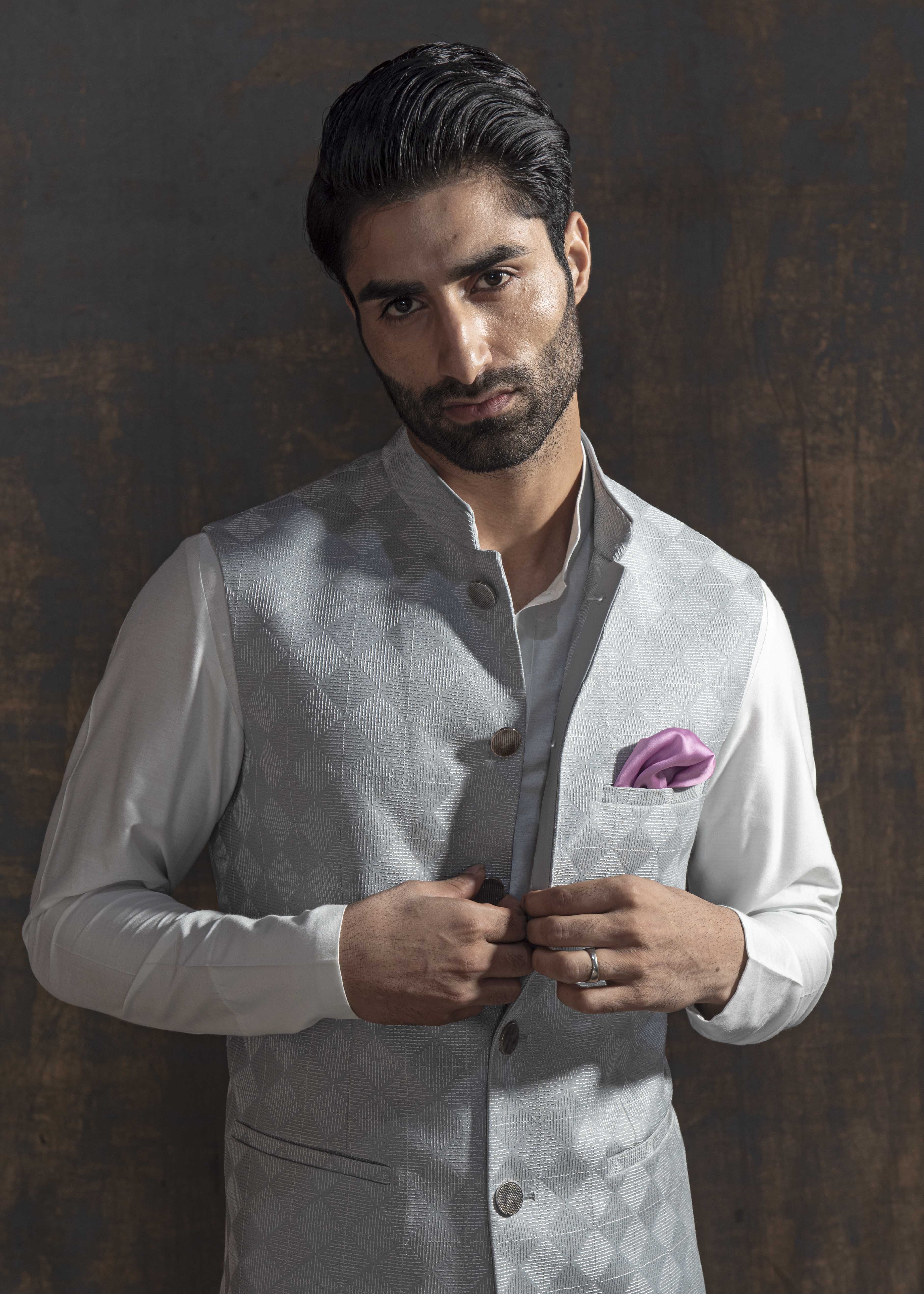 Grey embroidered nehru jacket with off white kurta pajama.