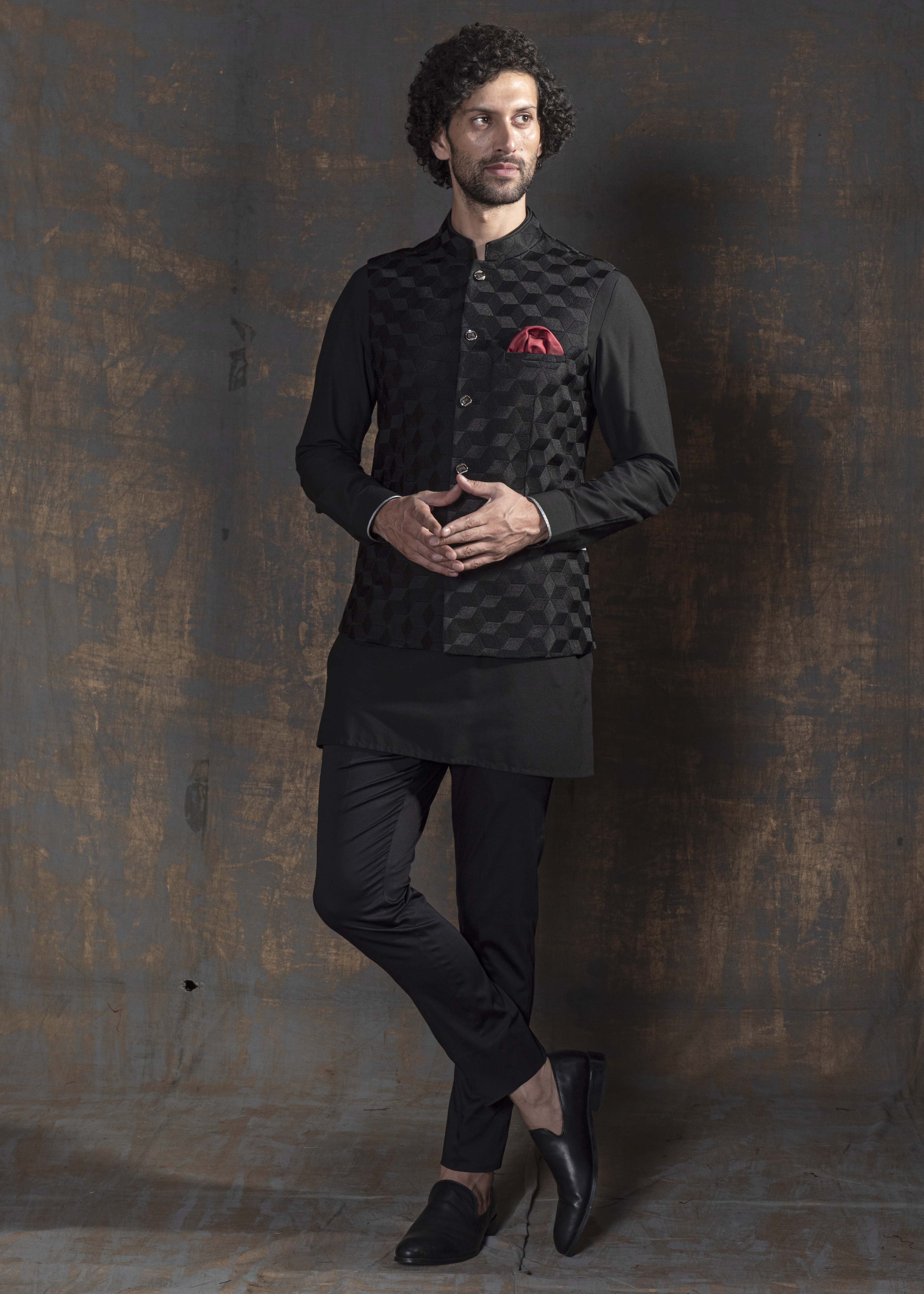 Black self embroidered nehru jacket. Paired up with black kurta pajama.