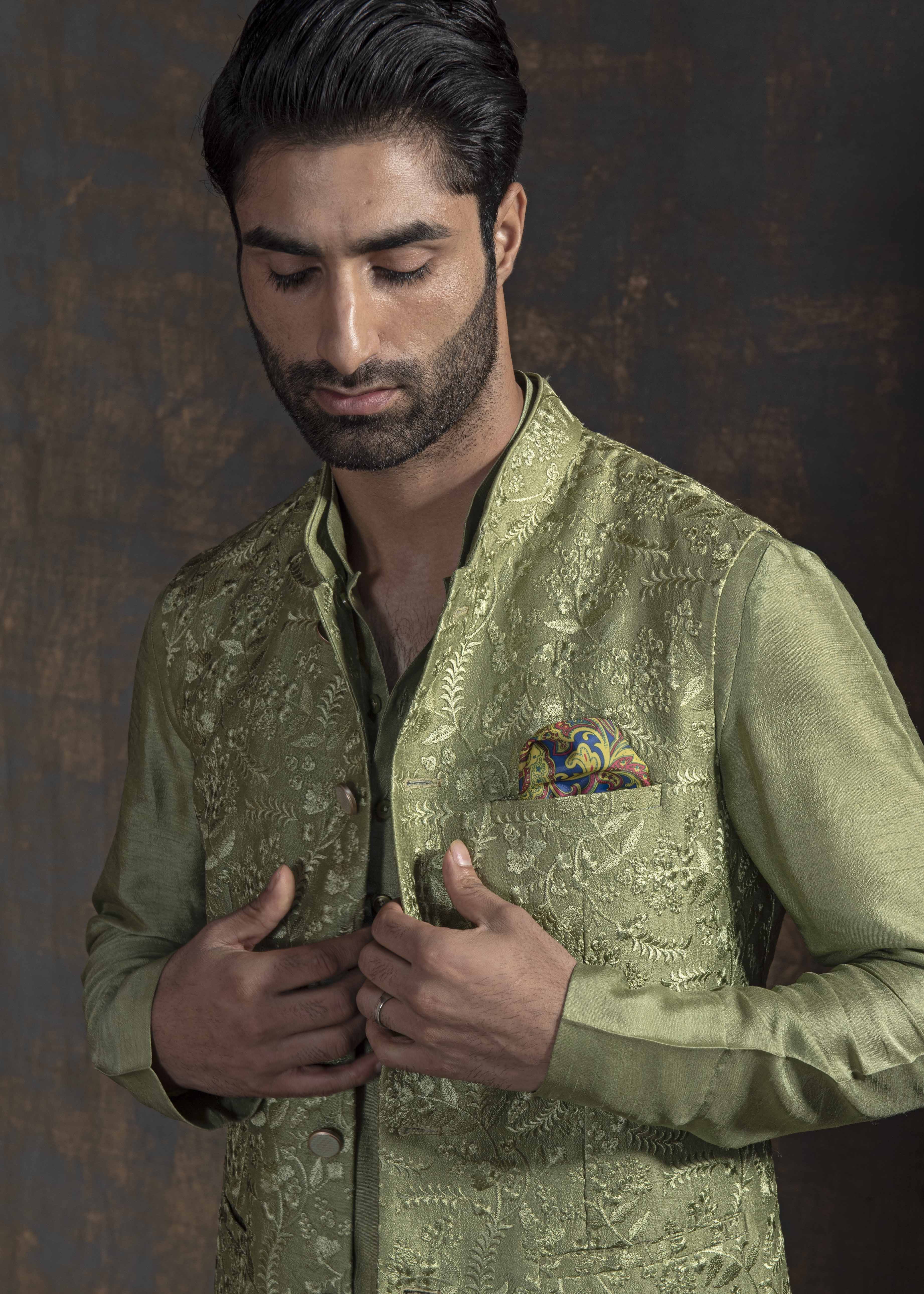 Green self embroidered nehru jacket.  Paired up with Green kurta and ivory pajama.