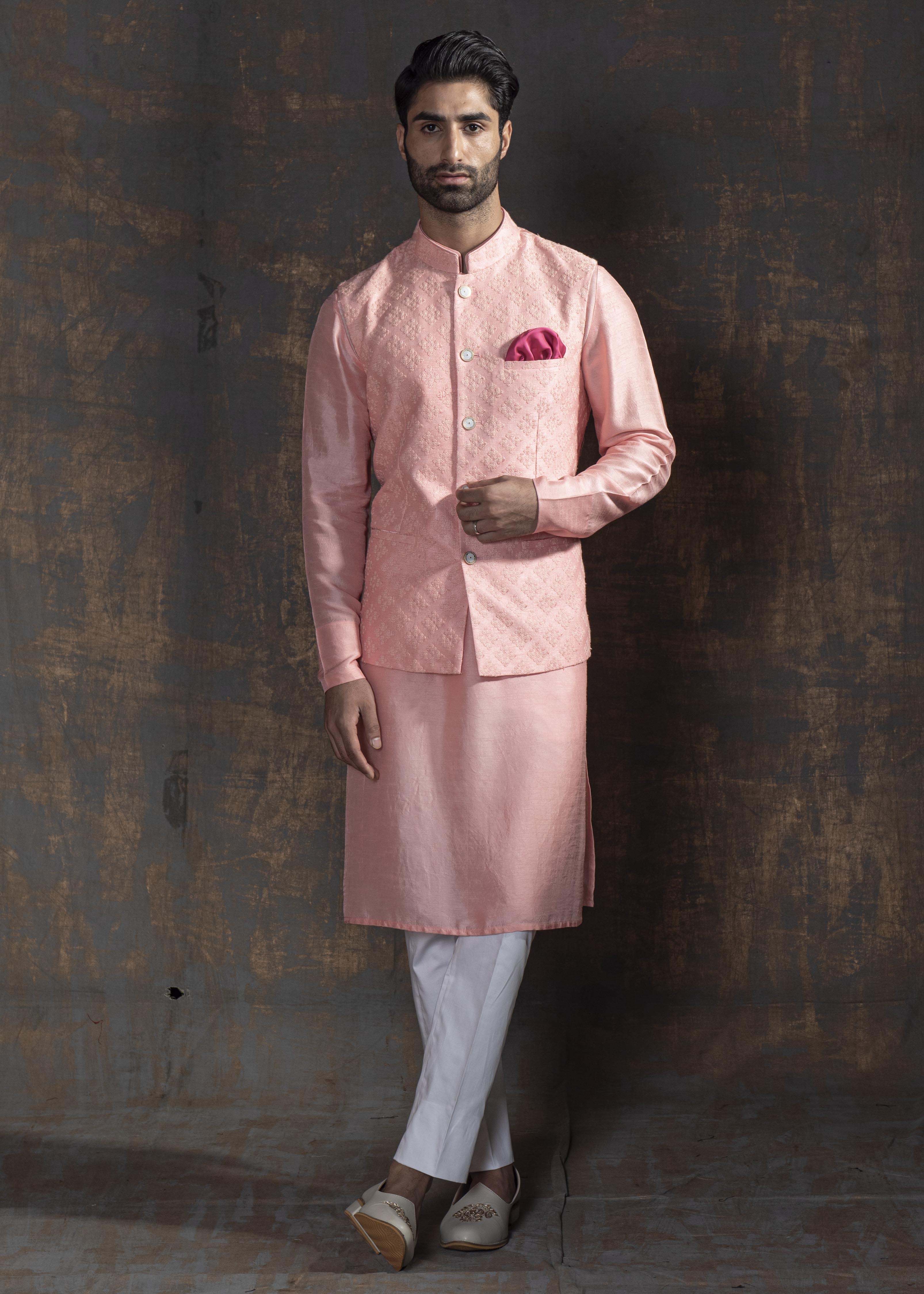 Pink self embroidered nehru jacket.  Paired up with pink kurta and ivory pajama.