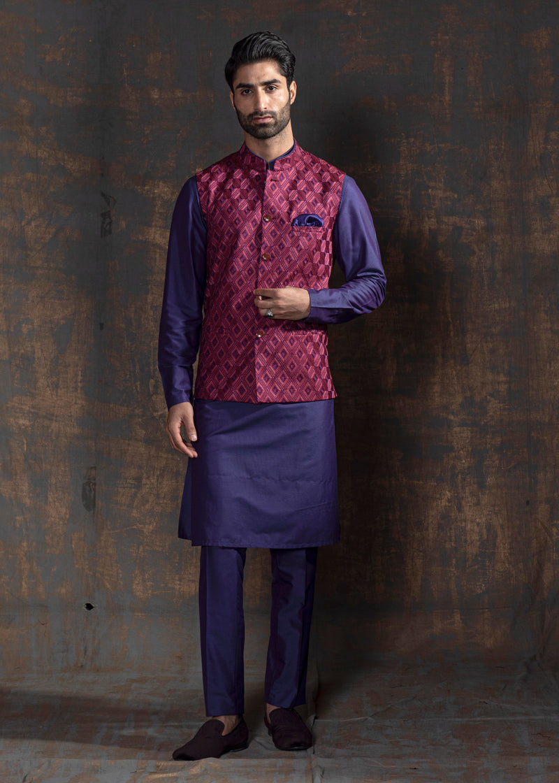 Mauve coloured self embroidered nehru jacket.  Paired up with purple kurta pajama.