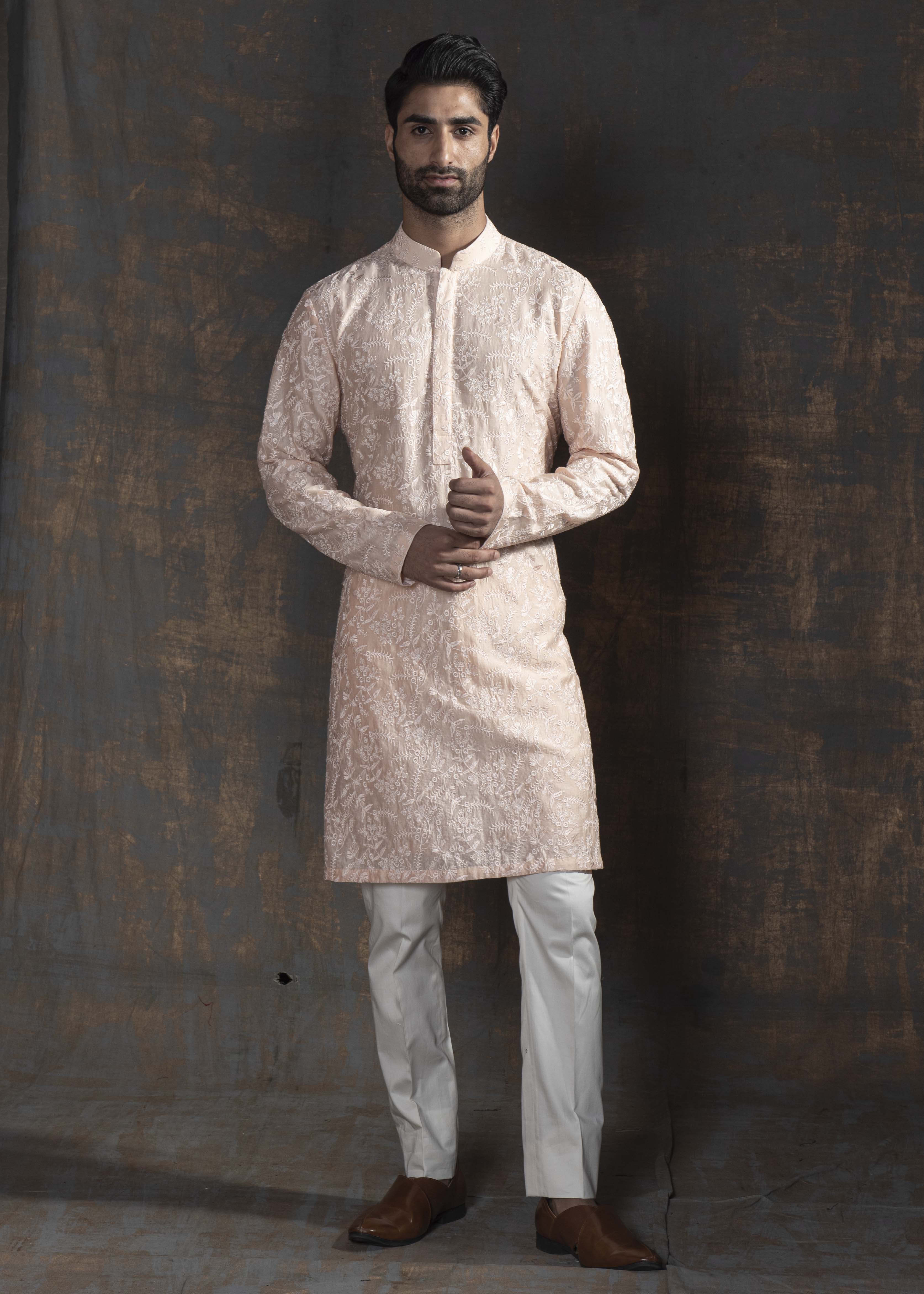 Powder pink embroidered kurta with ivory pants.