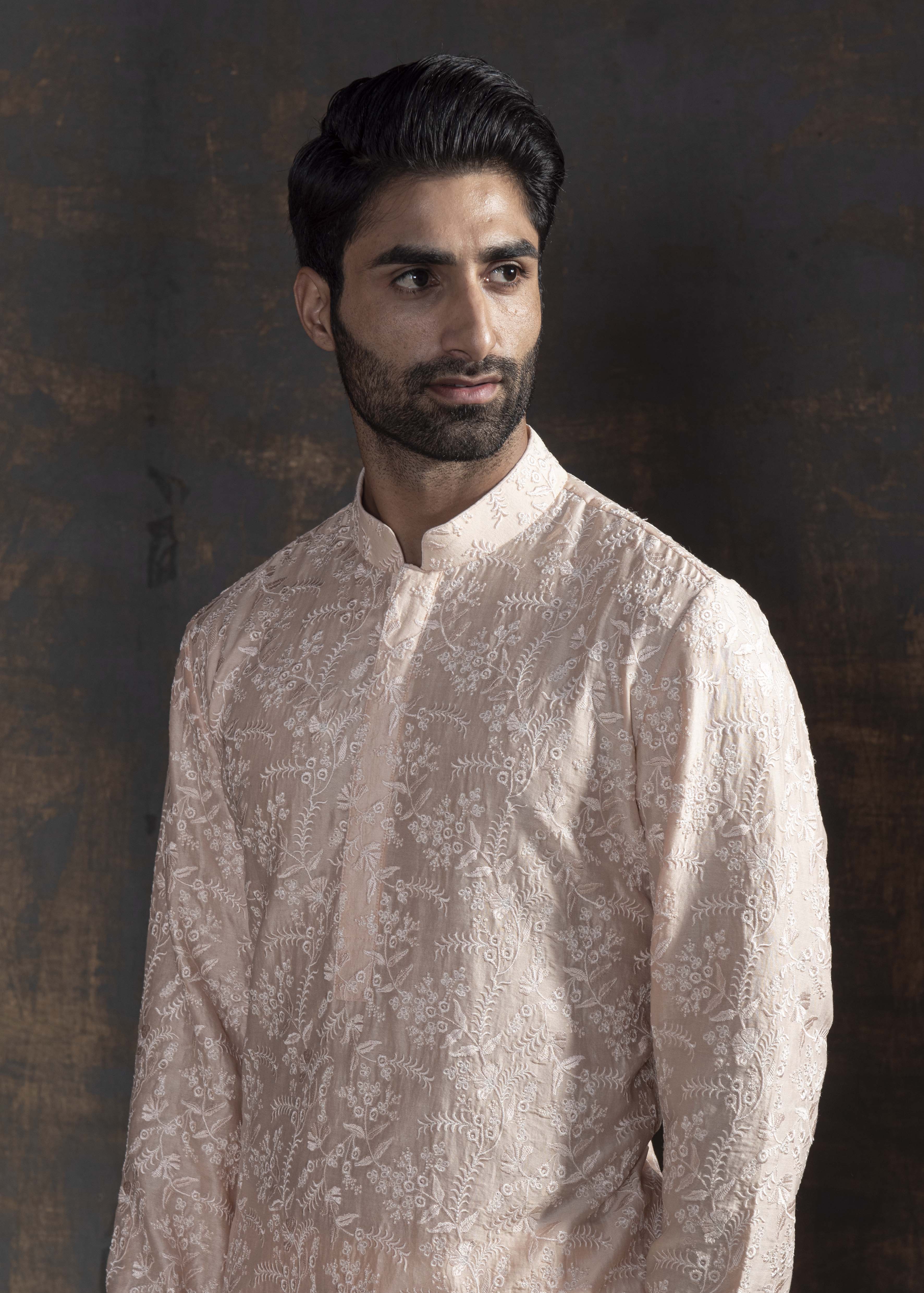 Powder pink embroidered kurta with ivory pants.