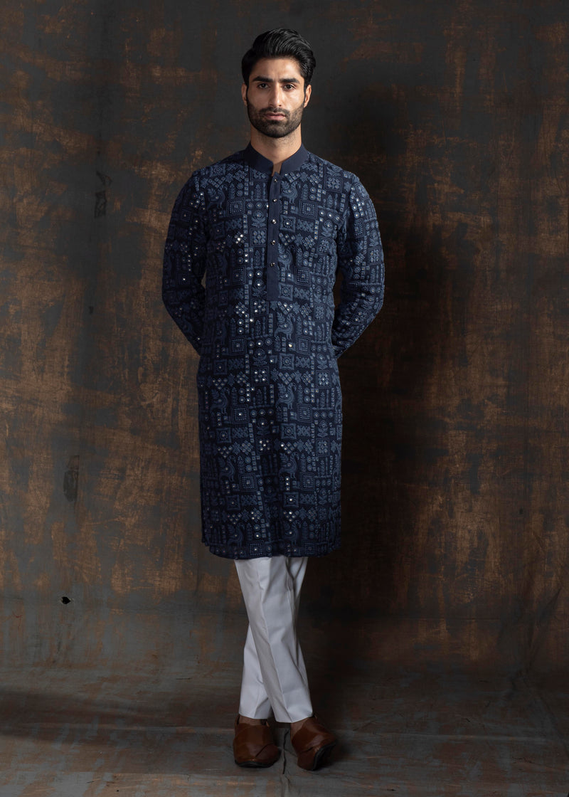 Blue embroidered kurta paired up with ivory pant pajama.