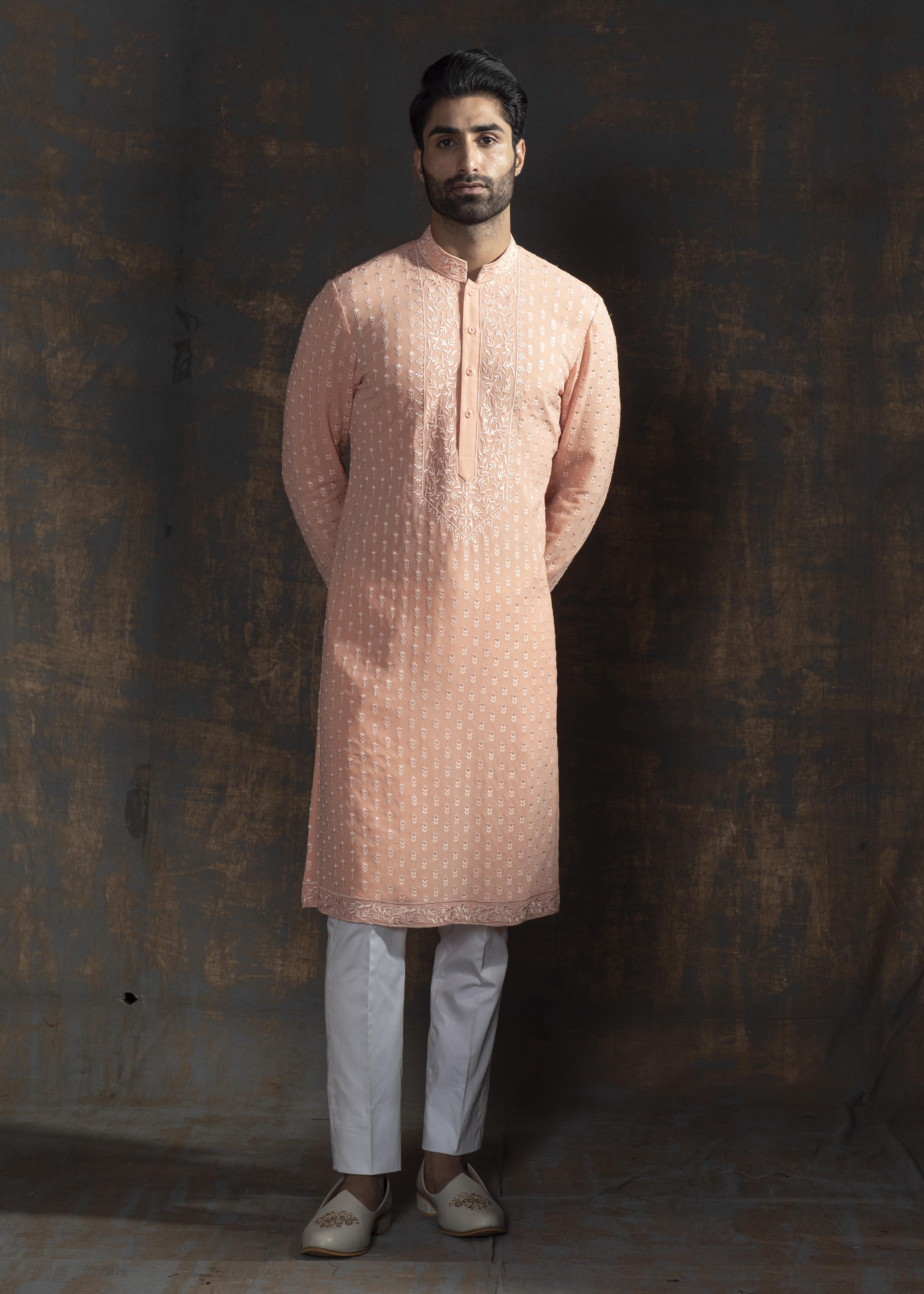 Rustish orange embroidered kurta paired up with ivory pant pajama.